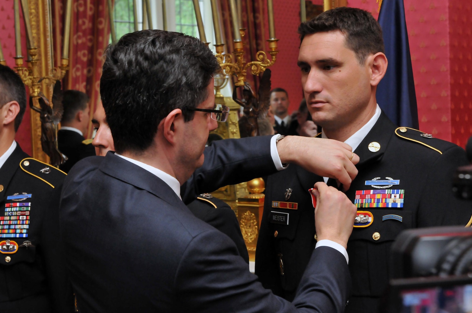 French Ambassador Francois Delattre awards the Croix de la Valeur Militaire, roughly analagous to the Silver Star, to Army National Guard Sgt. Ryan Meister during a private ceremony at the French Ambassador's Residence in Washington, D.C., on July 25, 2011, awarding the honor to five National Guard and one active duty Special Forces Soldiers. (U.S. Army photo by Staff Sgt. Jim Greenhill) (Released)