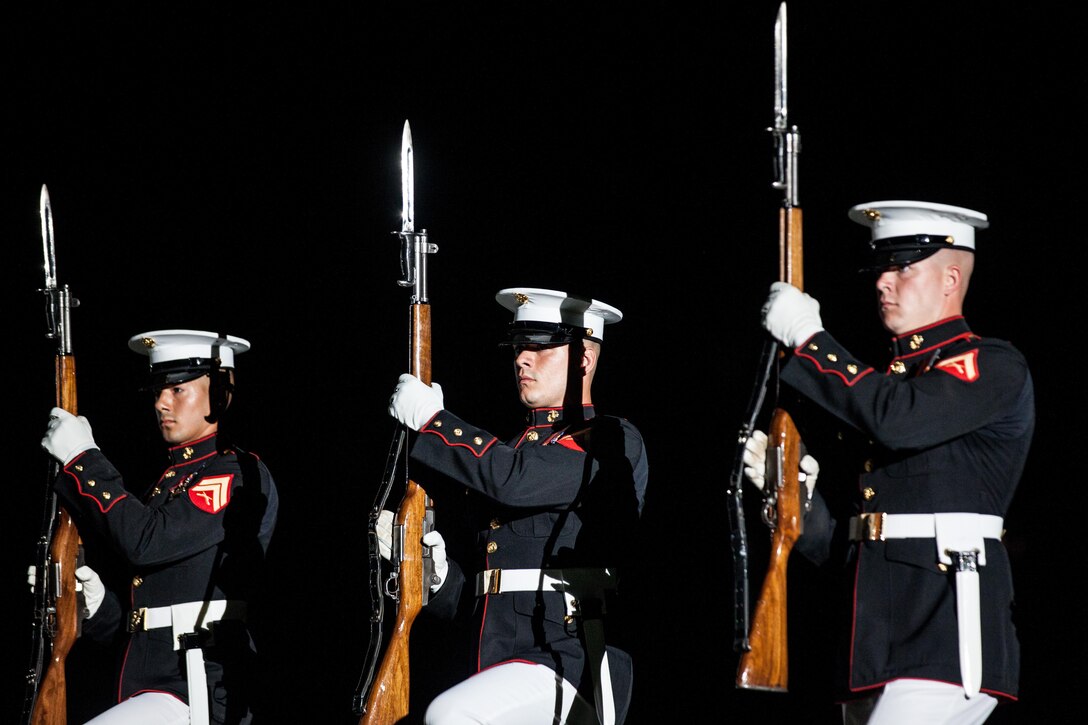 U.S. Marines with the Silent Drill Platoon perform during an evening parade at Marine Barracks Washington, D.C., July 31, 2015. U.S. Army General Martin E. Dempsey, chairman, Joint Chiefs of Staff, was the guest of honor for the parade at Marine Barracks Washington, D.C., and Gen. Joseph F. Dunford Jr., 36th commandant of the Marine Corps, was the hosting official for that same parade. The Evening Parade began in 1934 and features the Silent Drill Platoon, the U.S. Marine Band, the U.S. Marine Corps Drum and Bugle Corps, and two marching companies. More than 3500 guests attend the parade every week. (U.S. Marine Corps photo by Sgt. Melissa Marnell/Released)