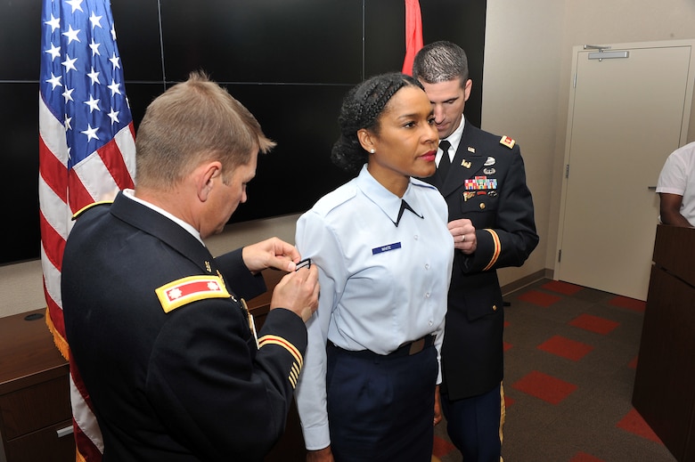 Lt. Col John L. Hudson (Left), former Nashville District commander, and Maj. Brad Morgan, former Nashville District deputy commander, promote Reserve Air Force Staff Sgt. Monica F. White to the rank of technical sergeant in a brief ceremony at the district headquarters in the Estes Kefauver Federal Building June 9, 2015.  