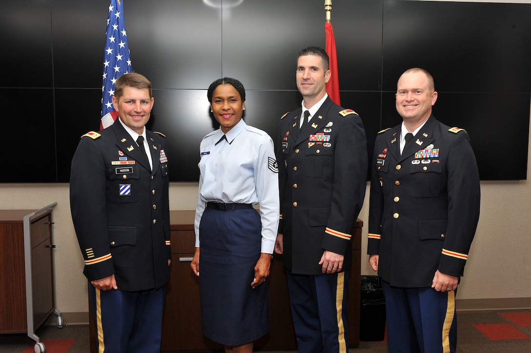 Reserve Air Force Staff Sgt. Monica F. White was promoted to technical sergeant by Lt. Col. John L. Hudson (Left), former U.S. Army Corps of Engineers Nashville District commander, in a brief ceremony at the district headquarters in the Estes Kefauver Federal Building June 9, 2015.   (Left to Right) Lt. Col. John L. Hudson, former U.S. Army Corps of Engineers Nashville District commander, Tech Sgt. Monica White, Maj. Brad Morgan, former U.S. Army Corps of Engineers Nashville District deputy commander, and Maj. Christopher Burkhart, incoming U.S. Army Corps of Engineers Nashville District deputy commander.