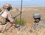 A west coast member of the Navy SEAL joint terminal attack controller team
works to set up a communication radio for calling aviation fire support with
Army 1st Lt. Matthew Lawson of the 1st Squadron, 82nd Cavalry Regiment's Fire
Support Team, from the Oregon National Guard's 41st Infantry Brigade Combat
Team, July 20, 2011, at Gowen Field, Idaho.