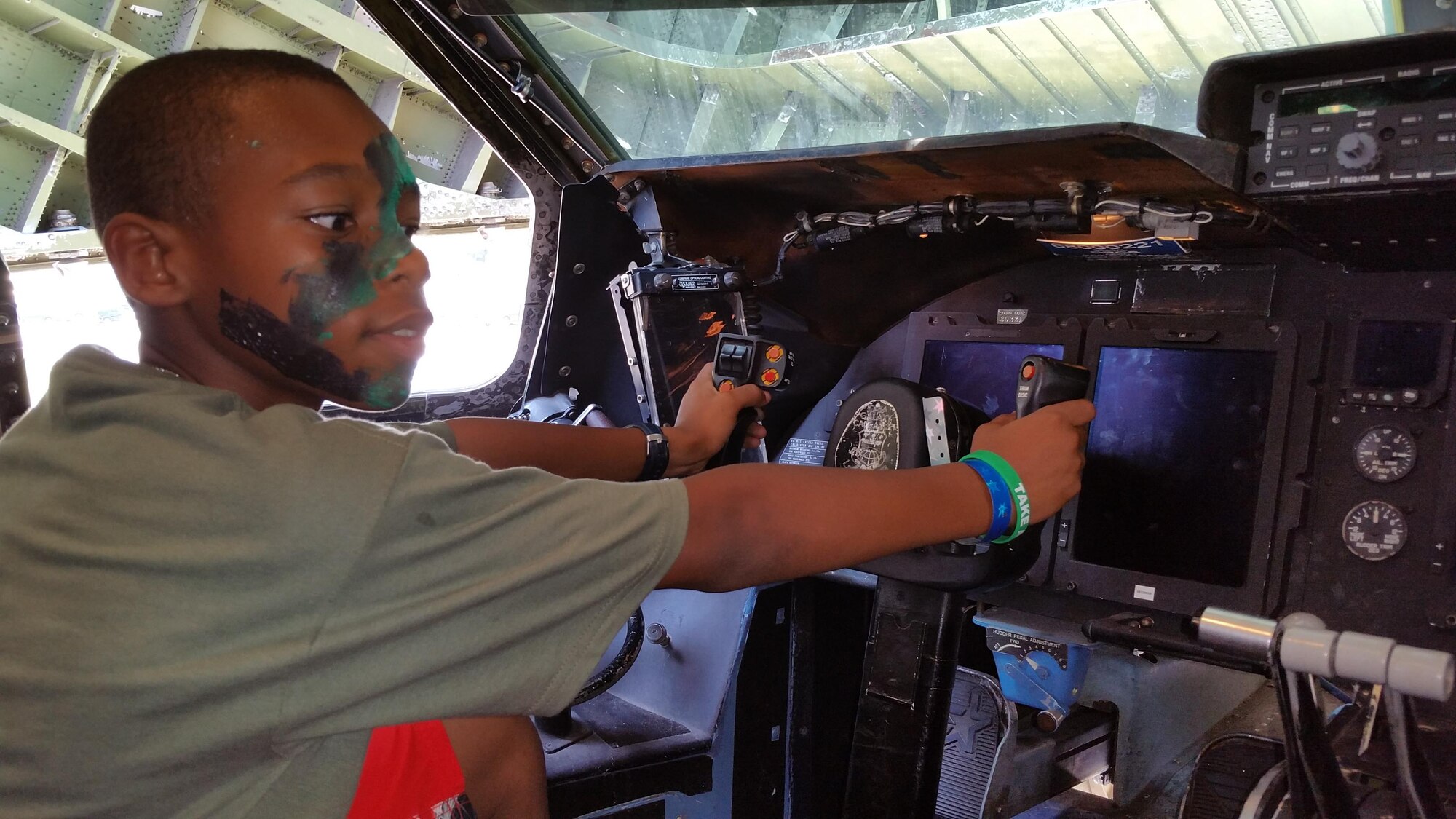 Jordan Davis handles the yoke of a 433rd Airlift Wing C-5A Galaxy on July 31, 2015 at Joint Base San Antonio, Texas during a mock deployment for military children. Jordan was one of over 200 children who took part in the event. Stations were set up to apply facial camouflage, do physical fitness activities, learn self aid and buddy care, and see weapons were among the features of the mock deployment. (U.S. Air Force photo/Tech. Sgt. Carlos J. Trevino)
