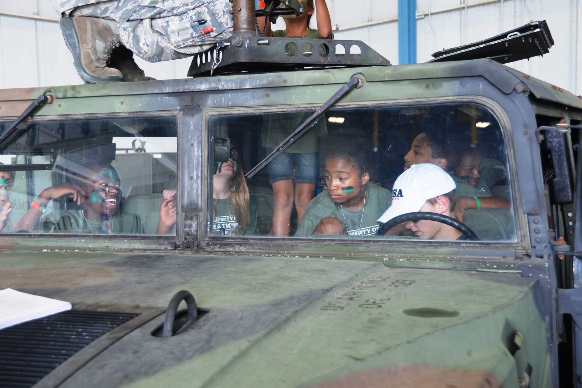 Children load up in a Humvee, during the 802nd Military and Family Readiness Center’s Operation Junior Expeditionary Team event, July 31, 2015 at Joint Base San Antonio-Lackland, Texas. More than 200 children participated in the annual event which is designed to provide children of military members the opportunity to experience the deployment process first hand.(U.S. Air Force photo/Minnie Jones)