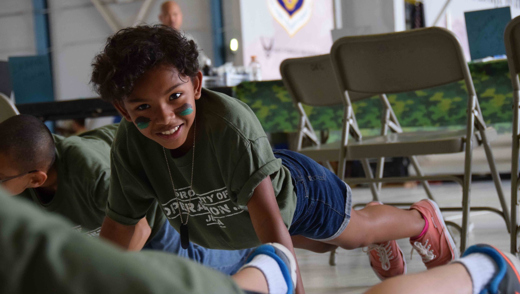 Mya Charles was one of 200 children who participated in Operation JET at Joint Base San Antonio-Lackland, Texas on July 31, 2015. One of the five stations she visited was the physical fitness area to do push ups, the obstacle course and agility challenges. (U.S. Air Force photo/Tech. Sgt. Carlos J. Trevino)