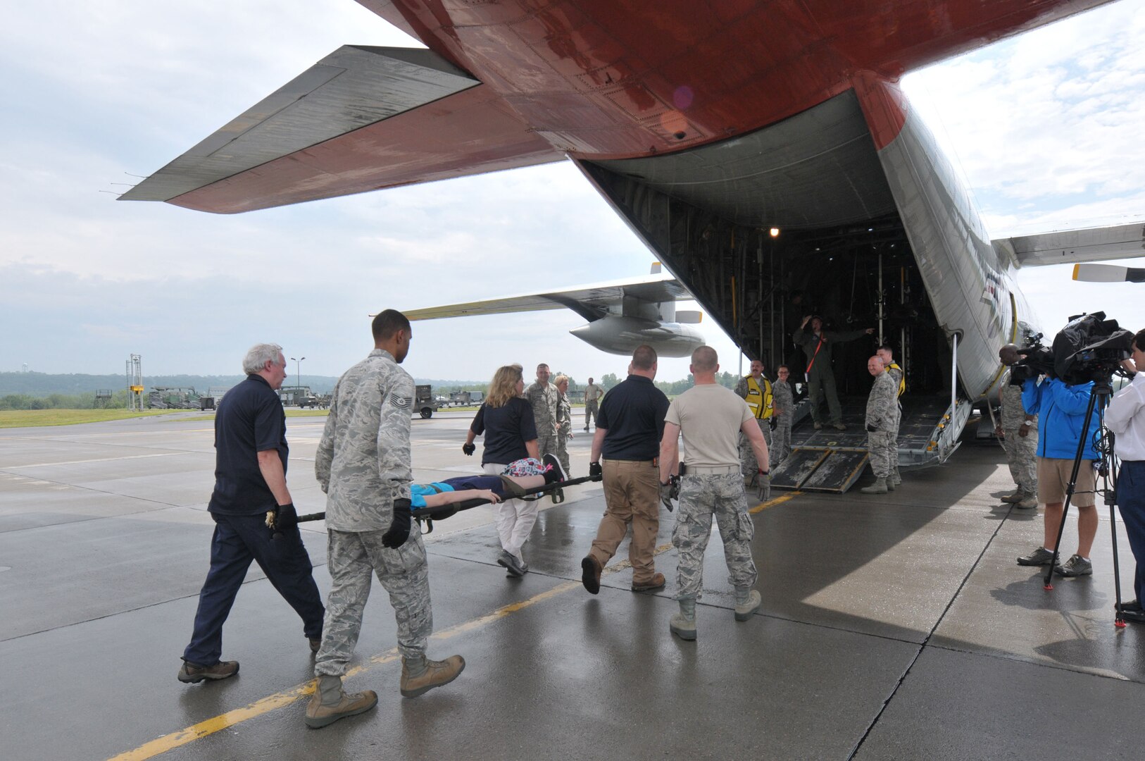 Members of the 139th Aeromedical Evacuation Squadron of the New York Air National Guard's 109th Airlift Wing, the 118th Medical Group Tennessee Air National guard and the Albany New York Veterans Administration members carry patients made up from the New York Civil Air Patrol from the staging area tent to a LC-130 Hercules aircraft during an exercise at Stratton Air National Guard Base, Scotia New York. 