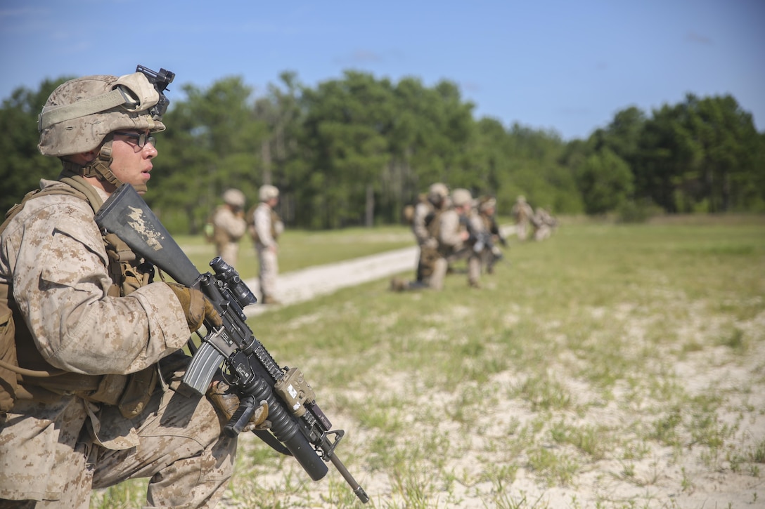 Lance Cpl. Joe Escobedo, a rifleman with Golf Company, 2nd Battalion, 2nd Marine Regiment, looks toward a target after conducting a squad attack at Marine Corps Base Camp Lejeune, North Carolina, July 28. The training incorporated multiple weapon systems, including the M16A4 service rifle, M203 grenade launcher, Shoulder-launched Multipurpose Assault Weapon and M249 Squad Automatic Weapon to help increase interoperability between weapons in training operations. (U.S. Marine Corps photo by Cpl. Lucas Hopkins/Released)