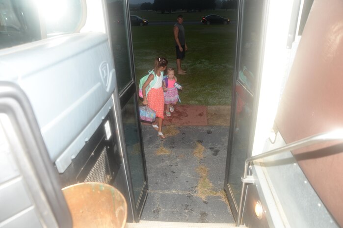 Two students board the bus on their first day of school