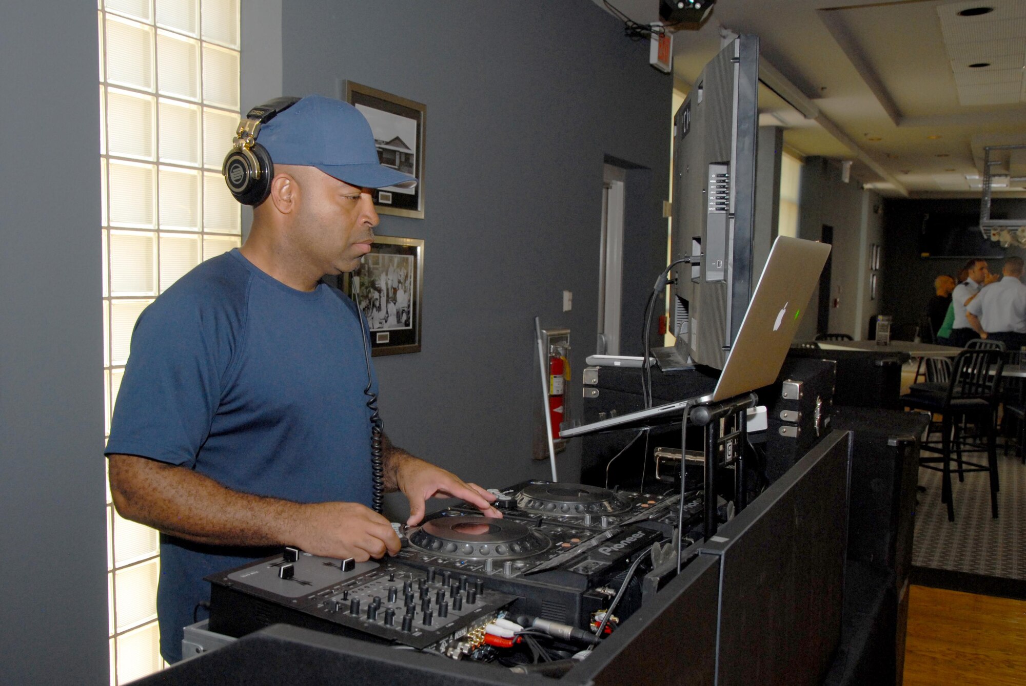 Omar S. Moore, 312th Training Squadron instructor, disk jockeys at the Doolittle Lounge reopening on Goodfellow Air Force Base, Texas, July 31, 2015. The reopening featured a raffle, buffet and a free commemorative glass for the first 100 customers. (U.S. Air Force photo by Senior Airman Joshua Edwards/Released)