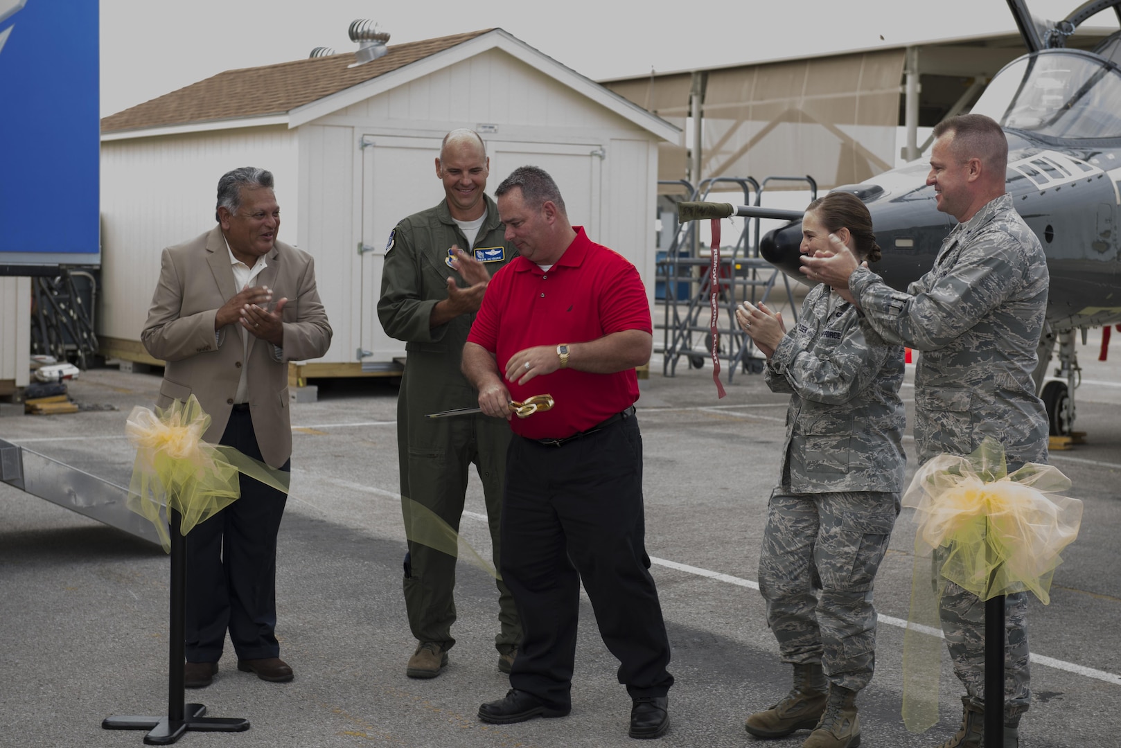 Robert Lewin, 575th Aircraft Maintenance Squadron director, cuts the ribbon at the unveiling ceremony of the first T-38 from the Pacer Classic III structural-modification program July 31, 2015, at Joint Base San Antonio-Randolph. Pacer Classic III is intended to ensure structural airworthiness of 150 T-38C aircraft and maintain T-38C fleet viability until 2029 and provides a bridge to the Air Force’s future trainer aircraft. 