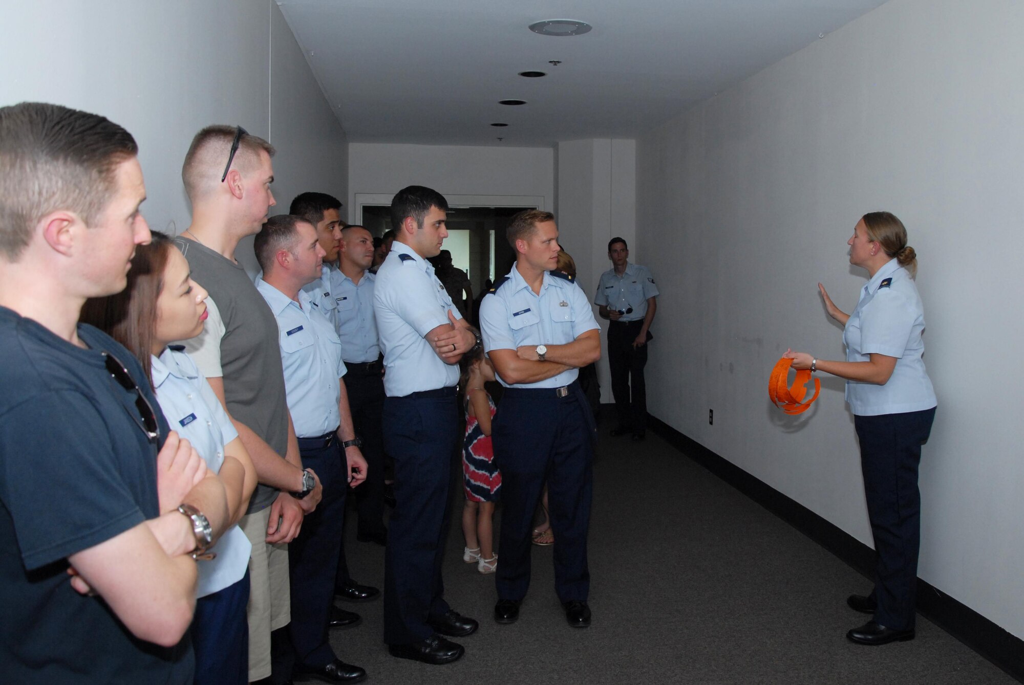 U.S. Air Force Maj. Paula A. Kelly, 17th Force Support Squadron deputy director, welcomes people to the Doolittle Lounge reopening on Goodfellow Air Force Base, Texas, July 31, 2015. Kelly also gave the first 100 customers a ticket to claim a free commemorative glass. (U.S. Air Force photo by Senior Airman Joshua Edwards/Released)