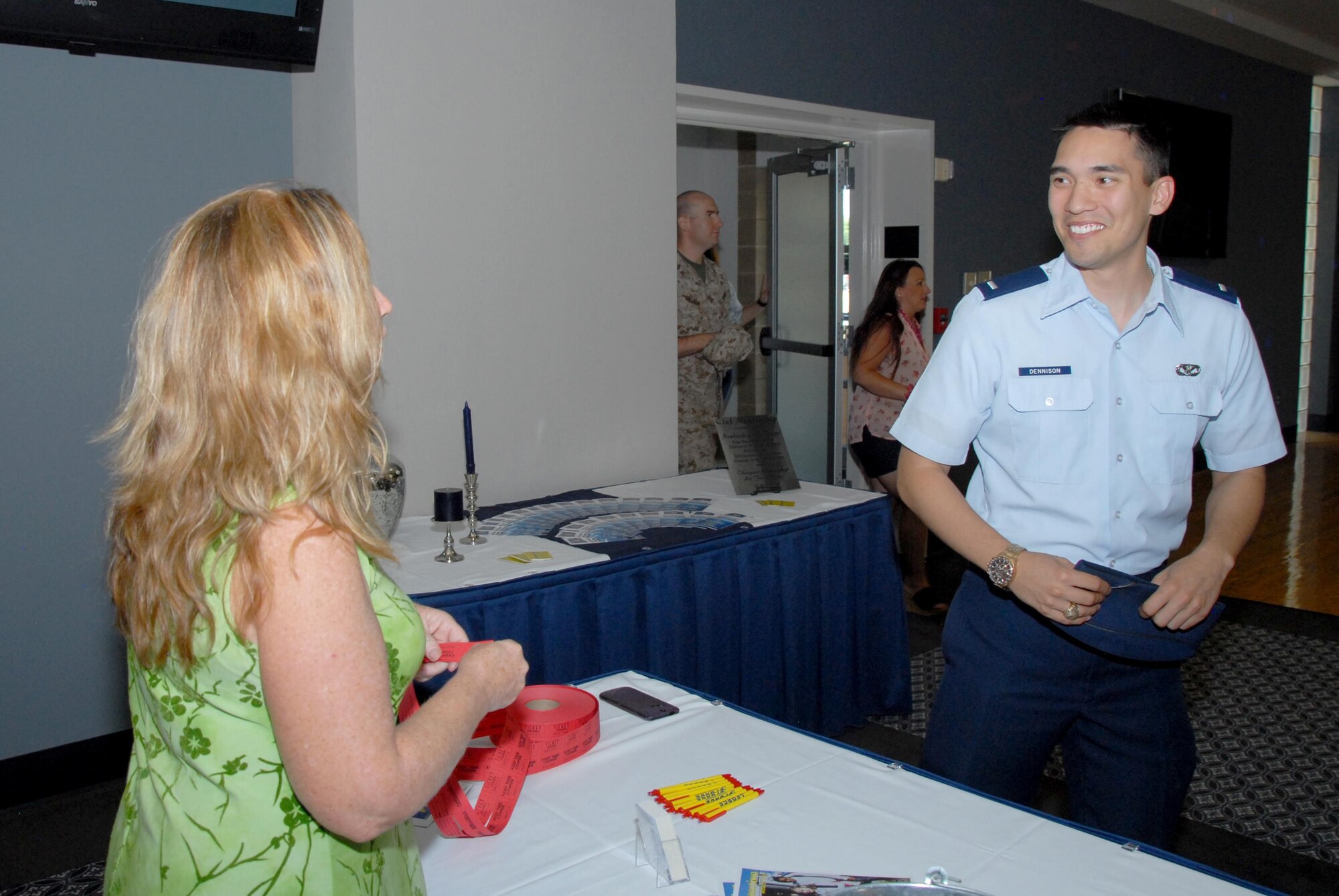U.S. Air Force 1st Lt. Paul P. Dennison, 17th Civil Engineer Squadron operations engineering element chief, signs up for a raffle at the Doolittle Lounge reopening on Goodfellow Air Force Base, Texas, July 31, 2015. The prizes included gift cards and a game console. (U.S. Air Force photo by Senior Airman Joshua Edwards/Released)