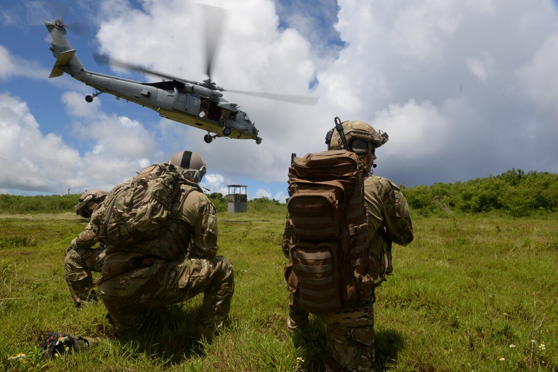 U.S. Air Force Tactical Air Control Party Airmen with the 3rd Air Support Operations Squadron from Joint Base Elmendorf-Richardson, Alaska, watch as an MH-60S Seahawk takes off July 22, 2015, Andersen Air Force Base, Guam. The joint terminal attack controller team conducted essential close air support training. (U.S. Air Force photo by Staff Sgt. Alexander W. Riedel/Released)
