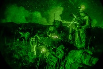 U.S. Air Force Tactical Air Control Party Airmen with the 3rd Air Support Operations Squadron watch as a MH-60S Seahawk performs close air support attack July 23, 2015, at Naval Ordnance Annex, Guam. The team conducted essential night qualifications training for joint terminal attack controllers. (U.S. Air Force photo by Alexander W. Riedel/Released)