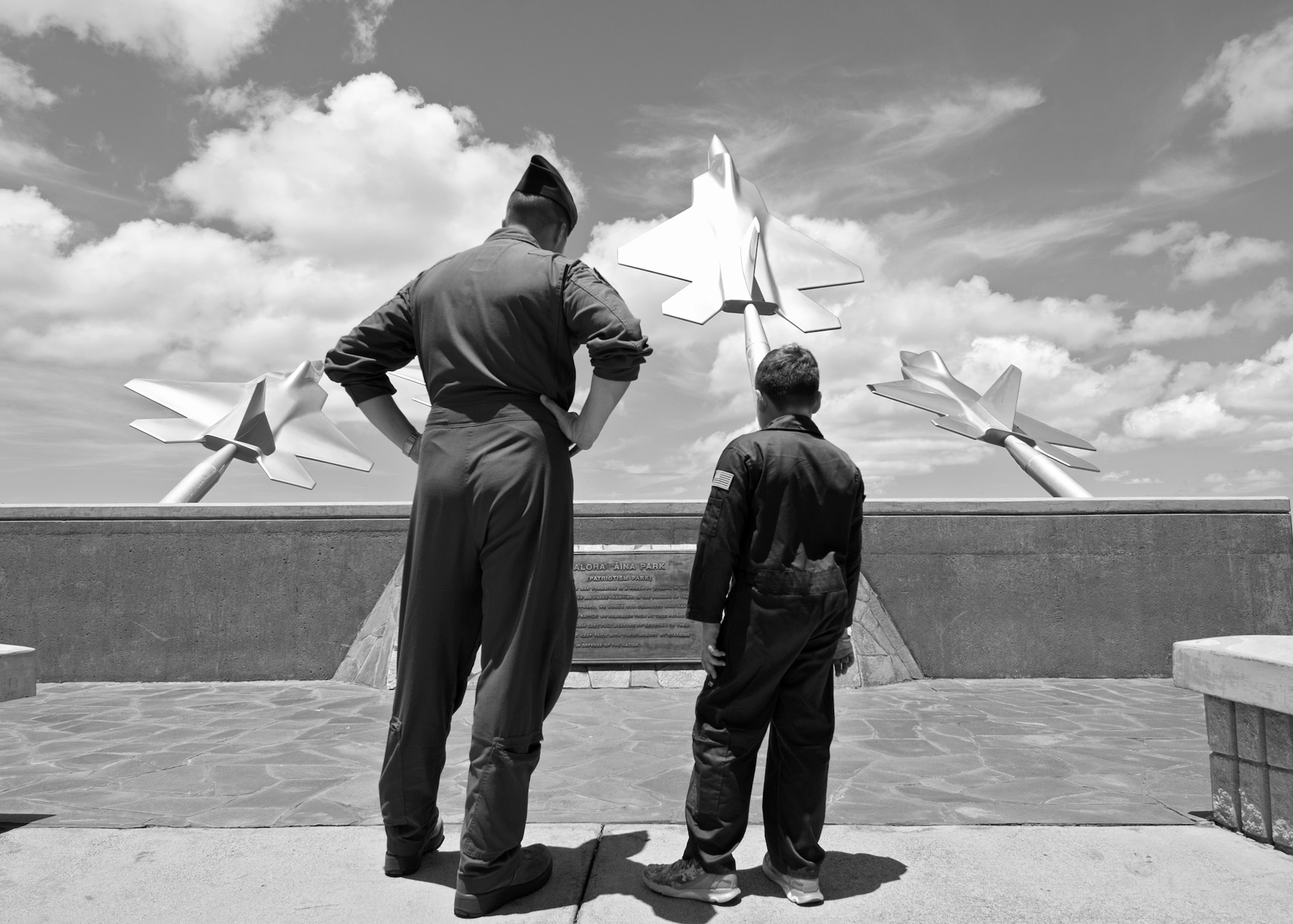 9-year-old Eddie Paul Bearb learns more about the Missing Man Formation from his Wingman U.S. Air Force Capt. John Clason, president of Pilot For A Day, a program that gave Eddie Paul the opportunity to take a break from the daily challenges he faces battling Acute Lymphoblastic Leukemia at Joint Base Pearl Harbor-Hickam, Hawaii, July 30, 2015. Eddie Paul spent the day being welcomed into the 535th Airlift Squadron as a Pilot For A Day. (U.S. Air Force photo by 2nd Lt. Kaitlin Daddona/Released)

