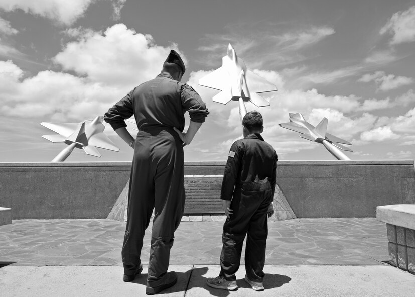 9-year-old Eddie Paul Bearb learns more about the Missing Man Formation from his Wingman U.S. Air Force Capt. John Clason, president of Pilot For A Day, a program that gave Eddie Paul the opportunity to take a break from the daily challenges he faces battling Acute Lymphoblastic Leukemia at Joint Base Pearl Harbor-Hickam, Hawaii, July 30, 2015. Eddie Paul spent the day being welcomed into the 535th Airlift Squadron as a Pilot For A Day. (U.S. Air Force photo by 2nd Lt. Kaitlin Daddona/Released)

