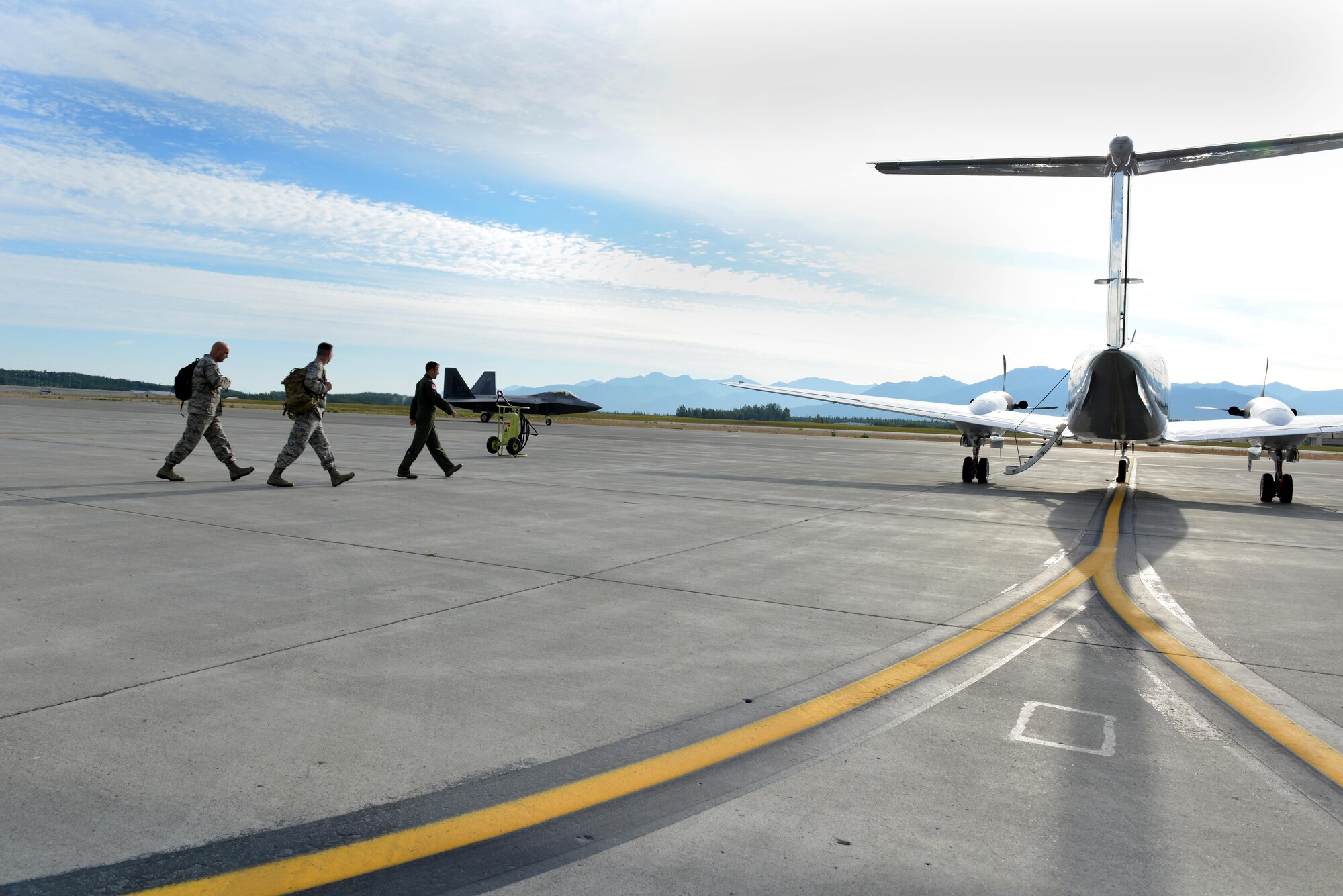 U.S. Air Force Col. Brian Bruckbauer, Joint Base Elmendorf-Richardson and 673rd Air Base Wing commander, and Lt. Col. Larry Corzine, Pacific Air Forces Regional Support Center deputy commander, follow Lt. Col. Blake Johnson, 517th Squadron commander and pilot for the trip, onto a U.S. Air Force C-12 designated to take them from JBER, Alaska, to Indian Mountain long-range radar site July 21, 2015. These radar sites track aircraft in American airspace to ensure unauthorized aircraft are not allowed in. (U.S. Air Force photo by Airman 1st Class Kyle Johnson/Released)