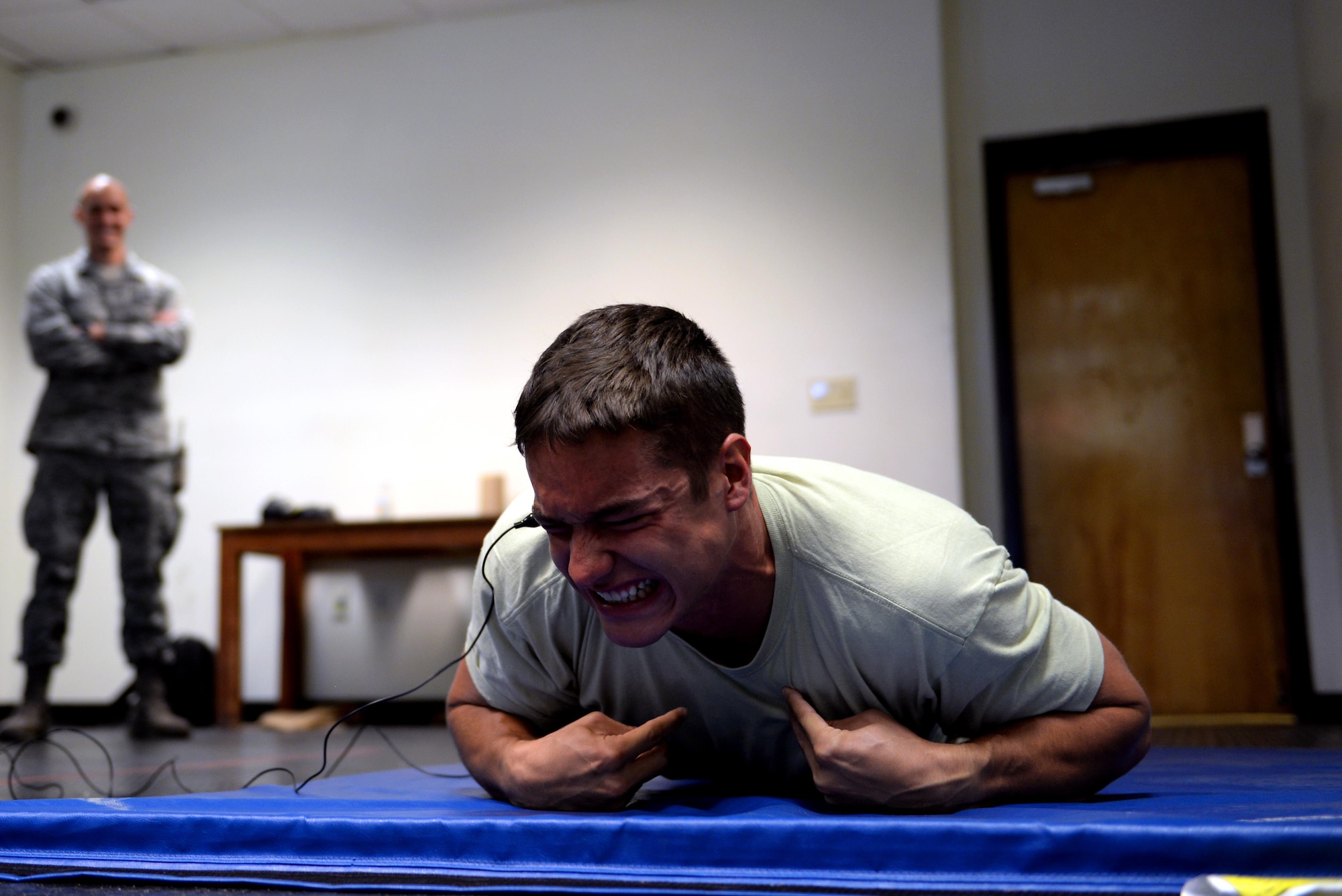 Cadet 2nd Class Jacob Riley, an Air Force Academy cadet, reacts to the electroshock from a Taser during a tour of the 81st Security Forces Squadron as part of Operation Air Force, July 23, 2015, Keesler Air Force Base, Miss. Available to Academy and ROTC cadets, OAF gives future Air Force officers an in-depth look at what the operational Air Force is like. The cadets toured organizations within the 81st Training Wing and 403rd Wing during their two-week stay. (U.S. Air Force photo by Airman 1st Class Duncan McElroy)