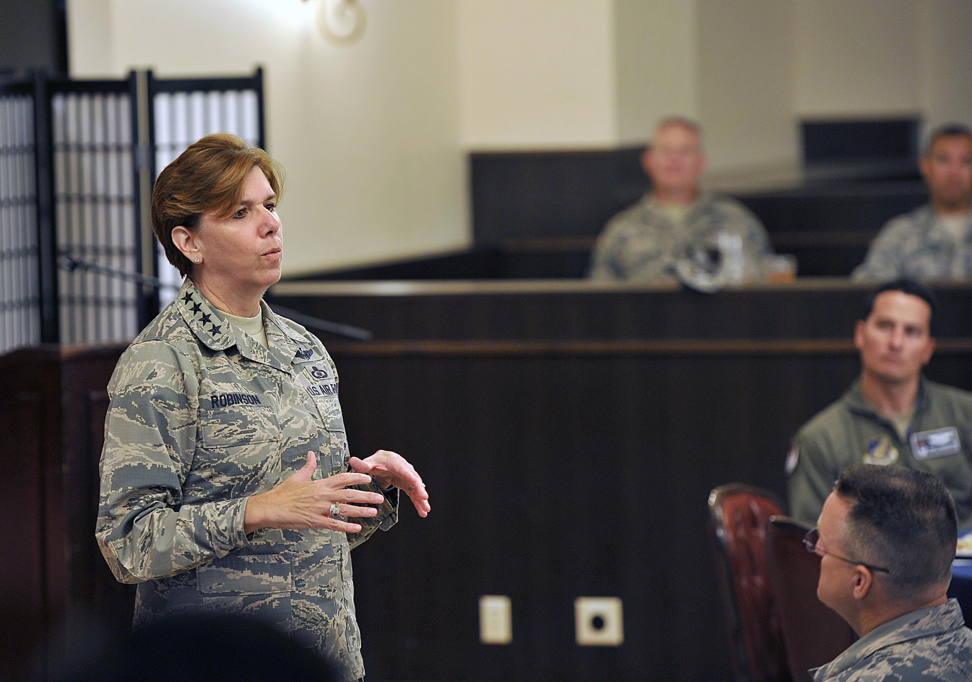 U.S. Air Force Gen. Lori J. Robinson, Pacific Air Forces commander, speaks to 18th Wing leaders and their spouses after a coin presentation at the Kadena Officer's Club on Kadena Air Base, Japan, Aug. 3, 2015. During her two-day visit to the base, Robinson presented coins to several Airmen from Kadena in honor of their outstanding performance in their Air Force careers. (U.S. Air Force photo by Naoto Anazawa/Released)


