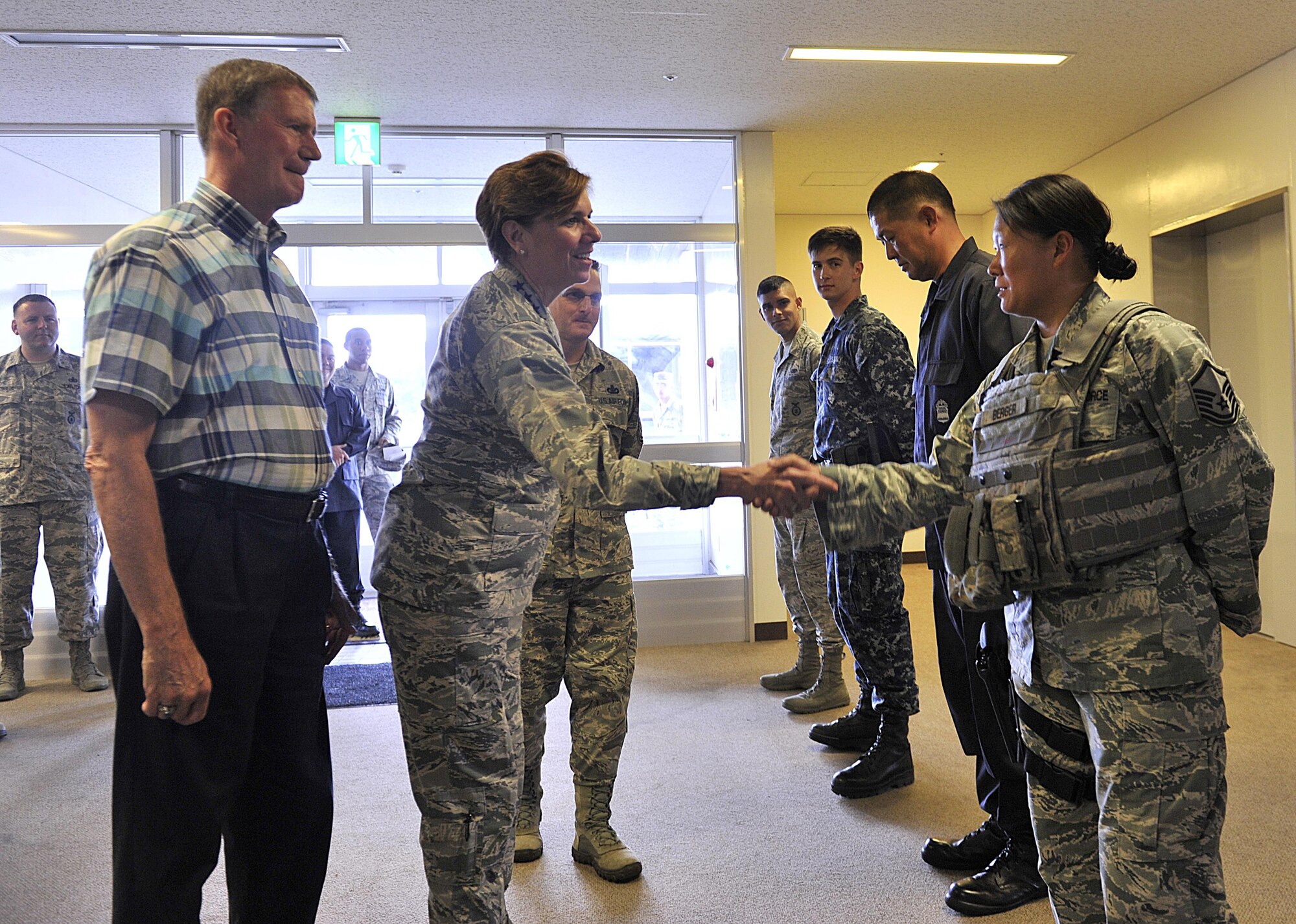 U.S. Air Force Gen. Lori J. Robinson, Pacific Air Forces commander, shake hands with U.S. Air Force Master Sgt. Lauren Berger, 18th Security Forces Squadron operations support, during a visit to Kadena Air Base, Japan, Aug. 3, 2015. During her two-day visit, the general addressed several issues that are important to her, including Airmen taking care of Airmen and the strategic shift to the Pacific. She also communicated her expectations with Kadena leaders. (U.S. Air Force photo by Naoto Anazawa/Released)