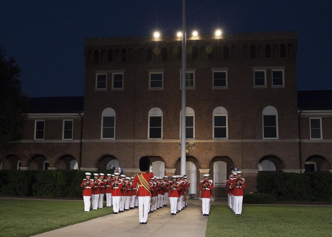 The U.S. Marine Band performs during an evening parade at Marine Barracks Washington, D.C., July 31, 2015. U.S. Army General Martin E. Dempsey, chairman, Joint Chiefs of Staff, was the guest of honor for the parade at Marine Barracks Washington, D.C., and Gen. Joseph F. Dunford Jr., 36th commandant of the Marine Corps, was the hosting official for that same parade. The Evening Parade began in 1934 and features the Silent Drill Platoon, the U.S. Marine Band, the U.S. Marine Corps Drum and Bugle Corps, and two marching companies. More than 3500 guests attend the parade every week. (U.S. Marine Corps photo by Lance Cpl. Christopher J. Nunn/Released)