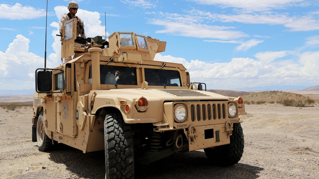 Marines with Truck Company, 3rd Marine Division, III Marine Expeditionary Force, standby for explosive ordnance disposal to arrive while keeping vigilant for possible enemy combatants during a motorized operations course aboard Marine Corps Air Ground Combat Center Twentynine Palms, Calif., July 30. The Marines performed the exercise to better themselves in the event of a real-life scenario.