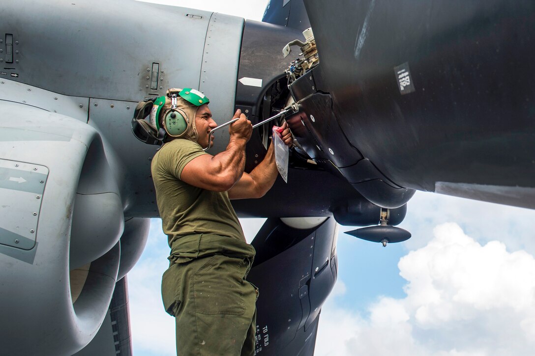 U.S. Marine Cpl. Raphael Velazquez maintains an MV-22 Osprey on the flight deck aboard the amphibious assault ship USS Kearsarge in the Atlantic Ocean,  Aug. 1, 2015. The Kearsarge Amphibious Ready Group and the 26th Marine Expeditionary Unit are conducting a composite training exercise to prepare for an upcoming deployment.