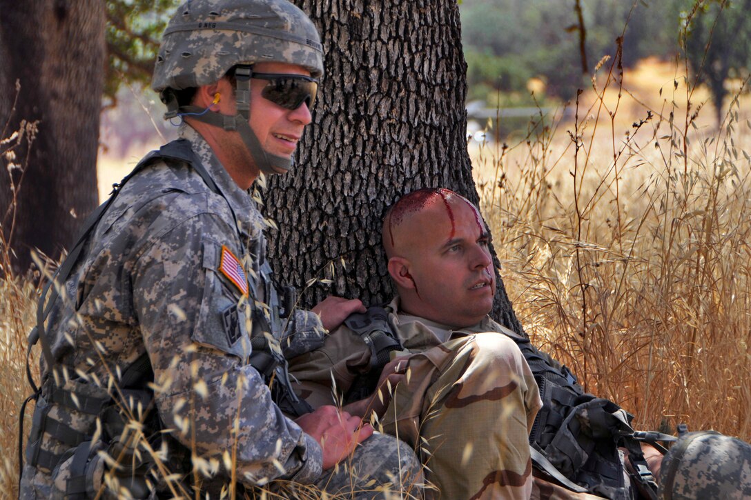 Army Spcs. Joshua Bevivino, left, and James Gipson participate in a mass casualty evacuation exercise on Fort Hunter Liggett, Calif., Aug. 2, 2015. Bevivino and Gipson are assigned to the 325th Combat Support Hospital.