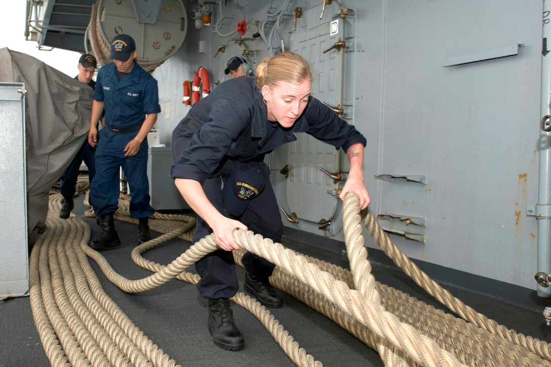 U.S. Navy Seaman Brittany A. Parker handles mooring lines on the fantail onboard the forward-deployed amphibious assault ship USS Bonhomme Richard as it leaves port in Darwin, Australia, July 27, 2015. 