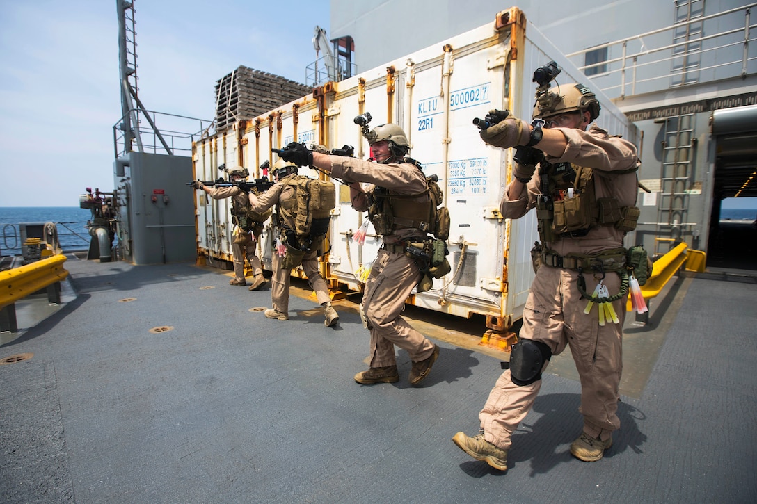 U.S. Marines clear a ship while conducting a joint visit, board, search, and seizure exercise during composite training unit exercise, or COMPTUEX, in the Atlantic Ocean, July 20, 2015.