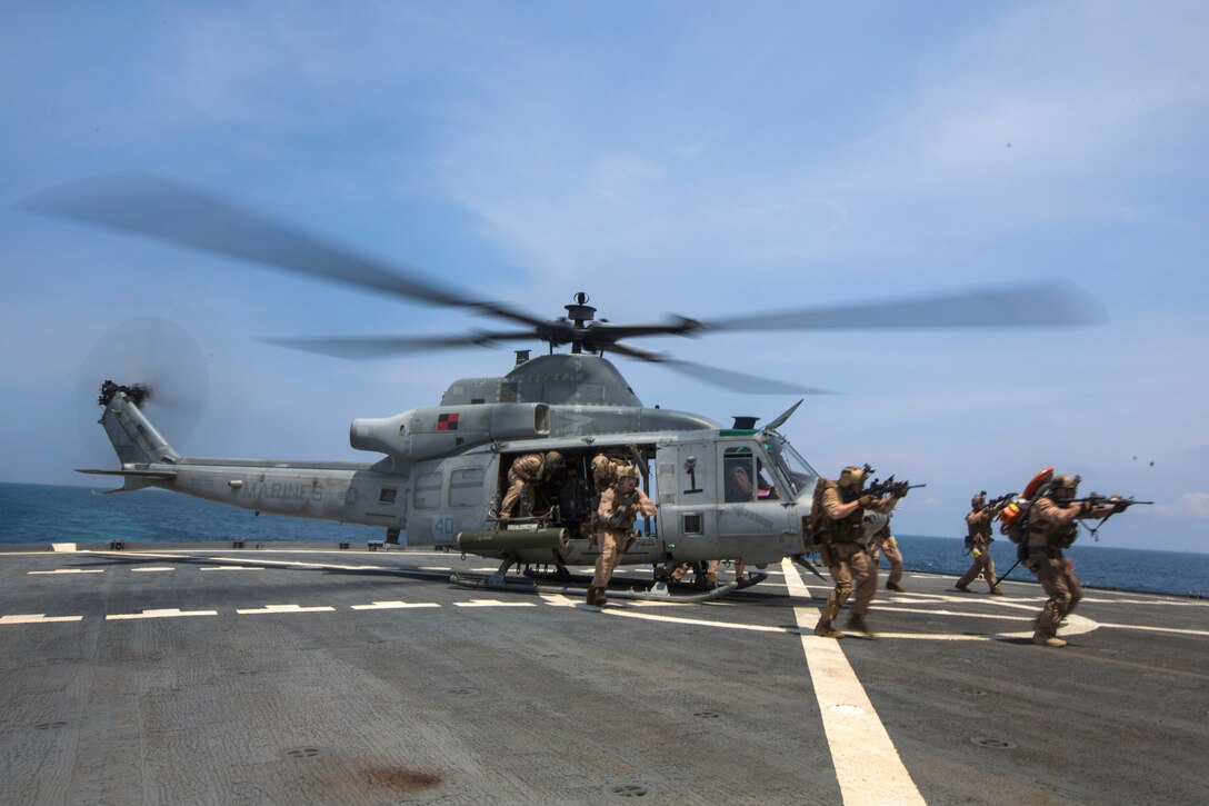 U.S. Marines board a ship from a UH-1Y Huey helicopter while conducting a joint visit, board, search, and seizure exercise during composite training unit exercise, or COMPTUEX, in the Atlantic Ocean, July 20, 2015.