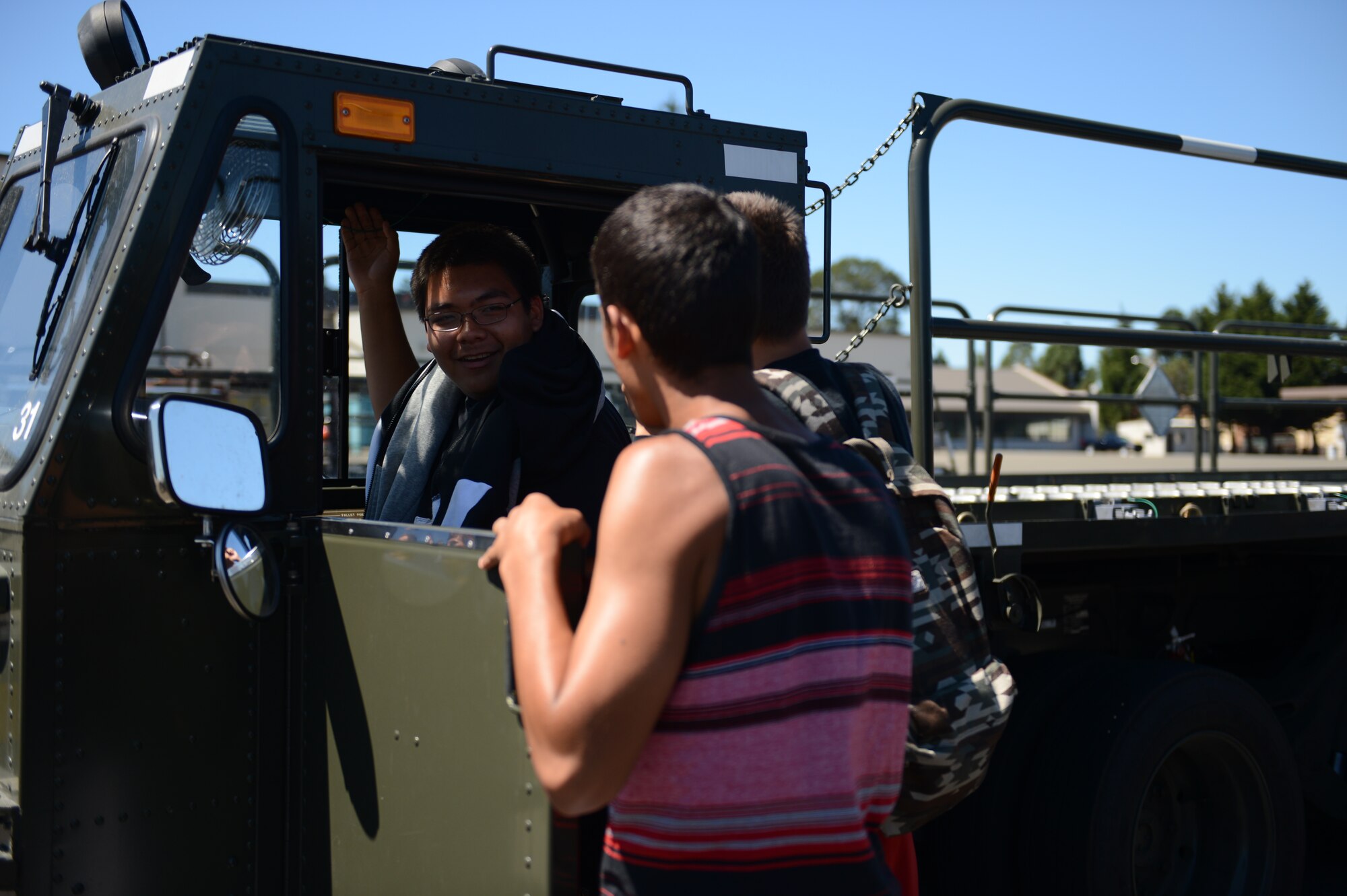 Members of the Nisqually Indian Tribe take turns honking the horn of a 60K loader, a vehicle which provides the capability to rapidly load and unload pallets from an aircraft, during their tour of McChord Field, Wash., July 30, 2015. The members of the Nisqually Indian Tribe were able to see the workings of the McChord Field Fire Station, the 627th Logistics Readiness Squadron, the 627th Security Forces Squadron, the 627th Communications Squadron, the 62nd Aerial Port Squadron, the 62nd Aircraft Maintenance Squadron and the 5th Air Support Operations Squadron. (U.S. Air Force photo/ Staff Sgt. Katie Jackson) 