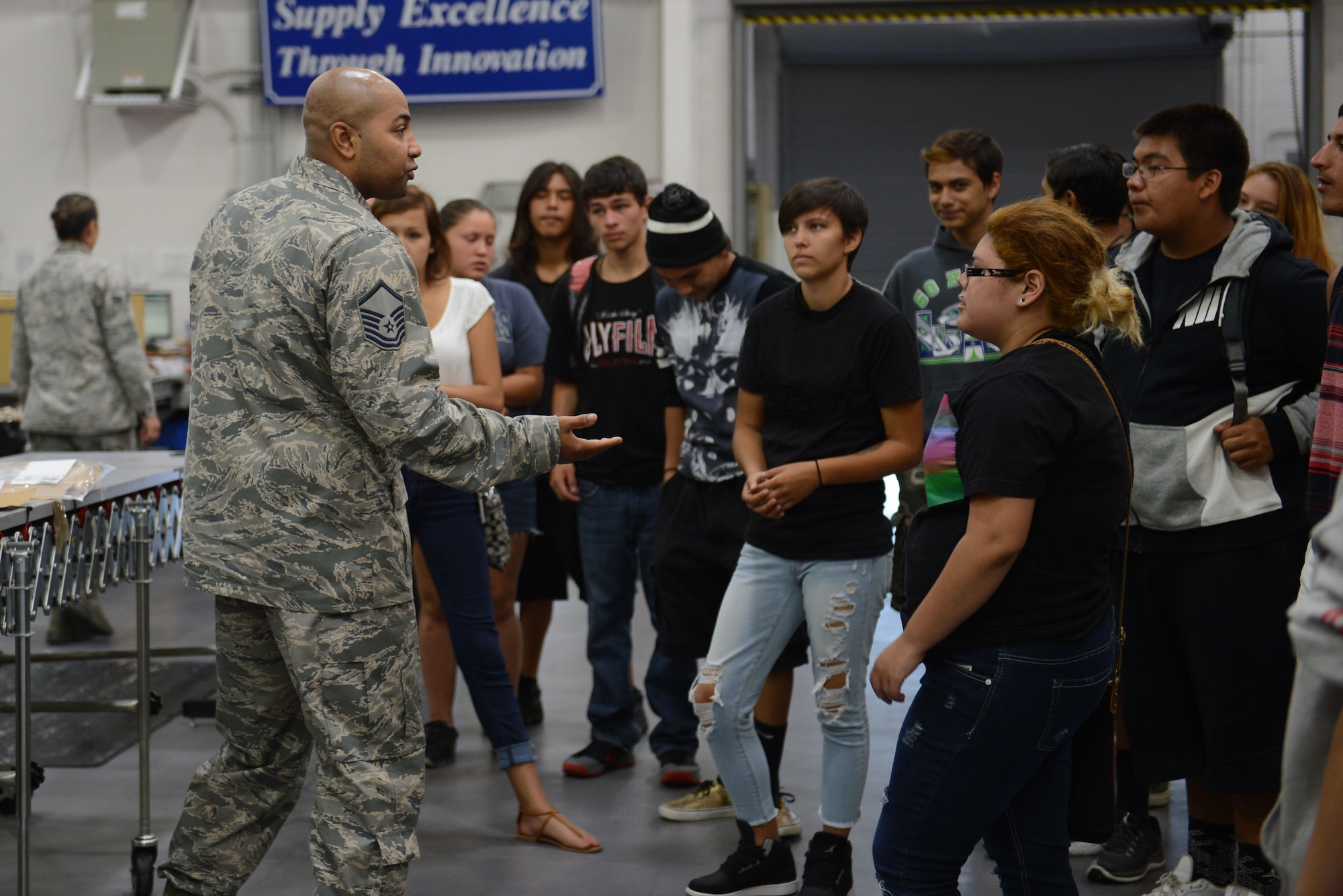 Master Sgt. Nahkoma Doyle, 627th Logistics Readiness Squadron section chief, explains the day-to-day workings of the aircraft parts store to members of the Nisqually Indian Tribe during their tour of McChord Field, Wash., July 30, 2015. The purpose of the tour was to begin a community partnership between the Nisqually Tribe and McChord Field. (U.S. Air Force photo/ Staff Sgt. Katie Jackson) 