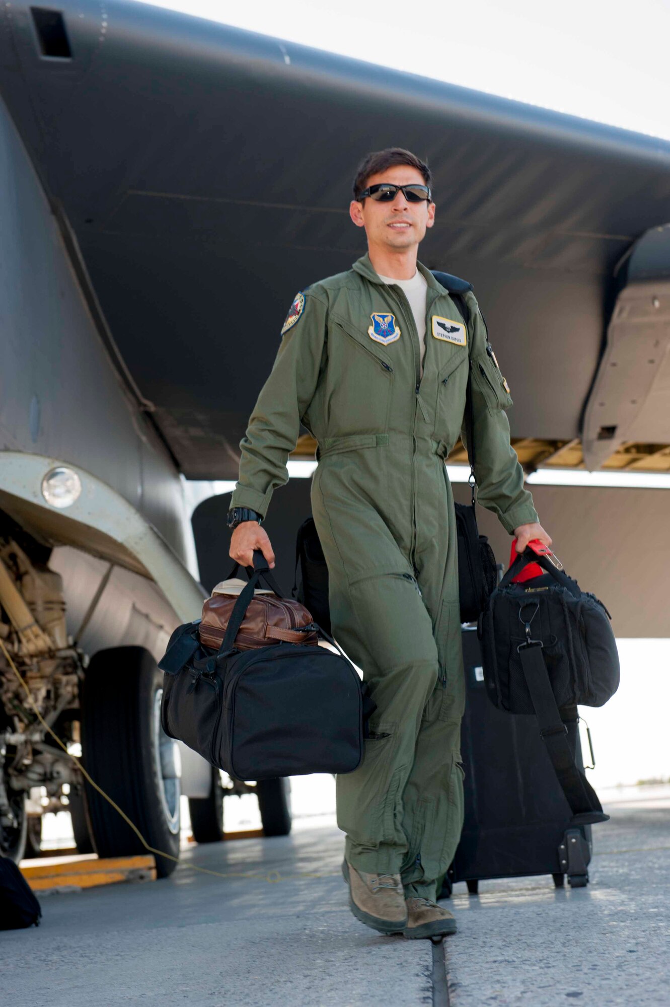 1st Lt. Stephen, 69th Bomb Squadron, carries his luggage to the bus at Minot Air Force Base, N.D., July 31, 2015. Dupuis participated in exercise Red Flag 15-3 which provided crew realistic air combat missions in a training environment. (U.S. Air Force photo/Airman 1st Class Sahara L. Fales)