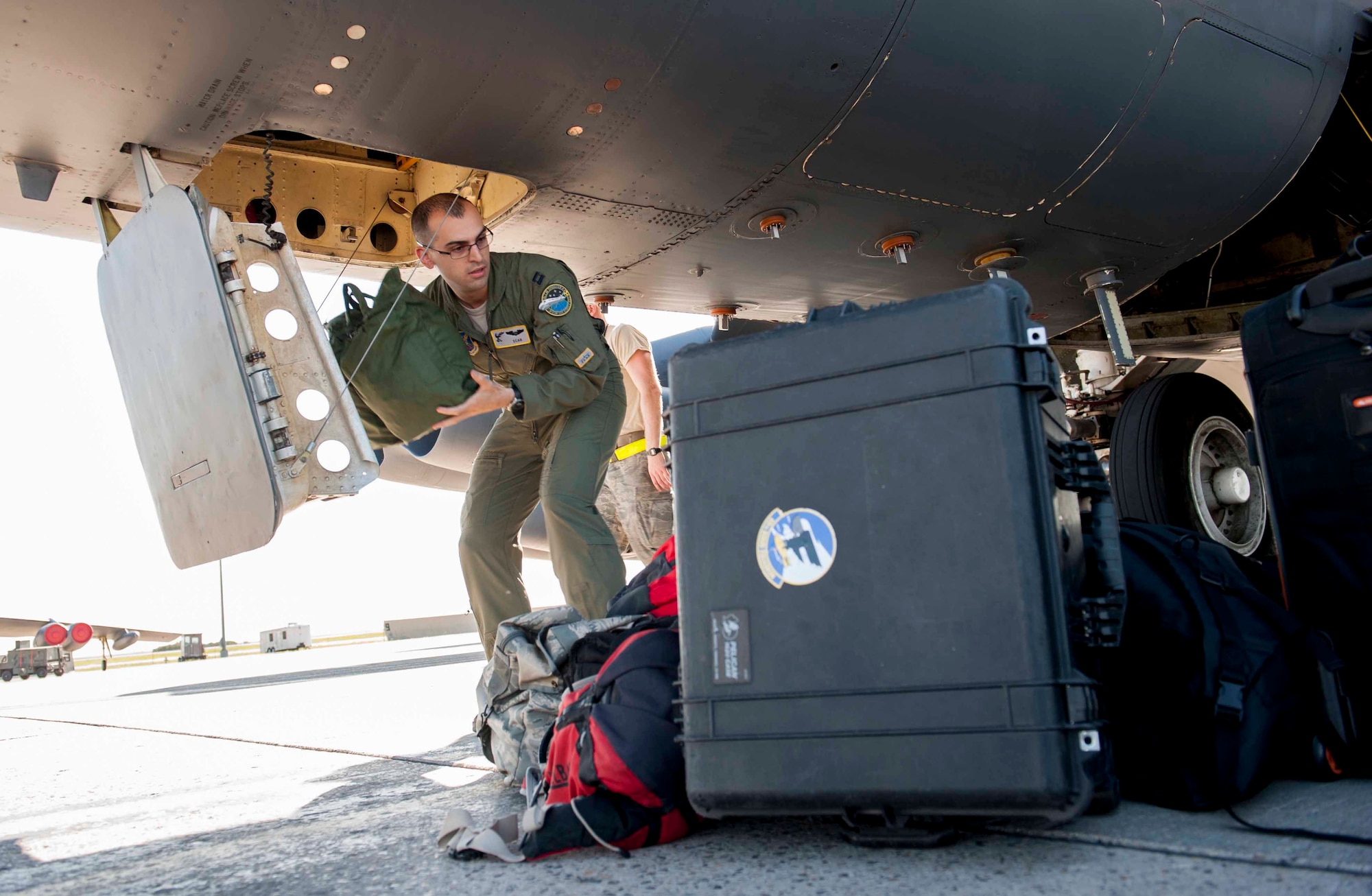 Capt. Jared, 69th Bomb Squadron, unloads bags from a B-52H Stratofortress at Minot Air Force Base, N.D., July 31, 2015. 69th BS crews returned from a three-week-long exercise, Red Flag 15-3, which took place at Nellis AFB, Nev. (U.S. Air Force photo/Airman 1st Class Sahara L. Fales)