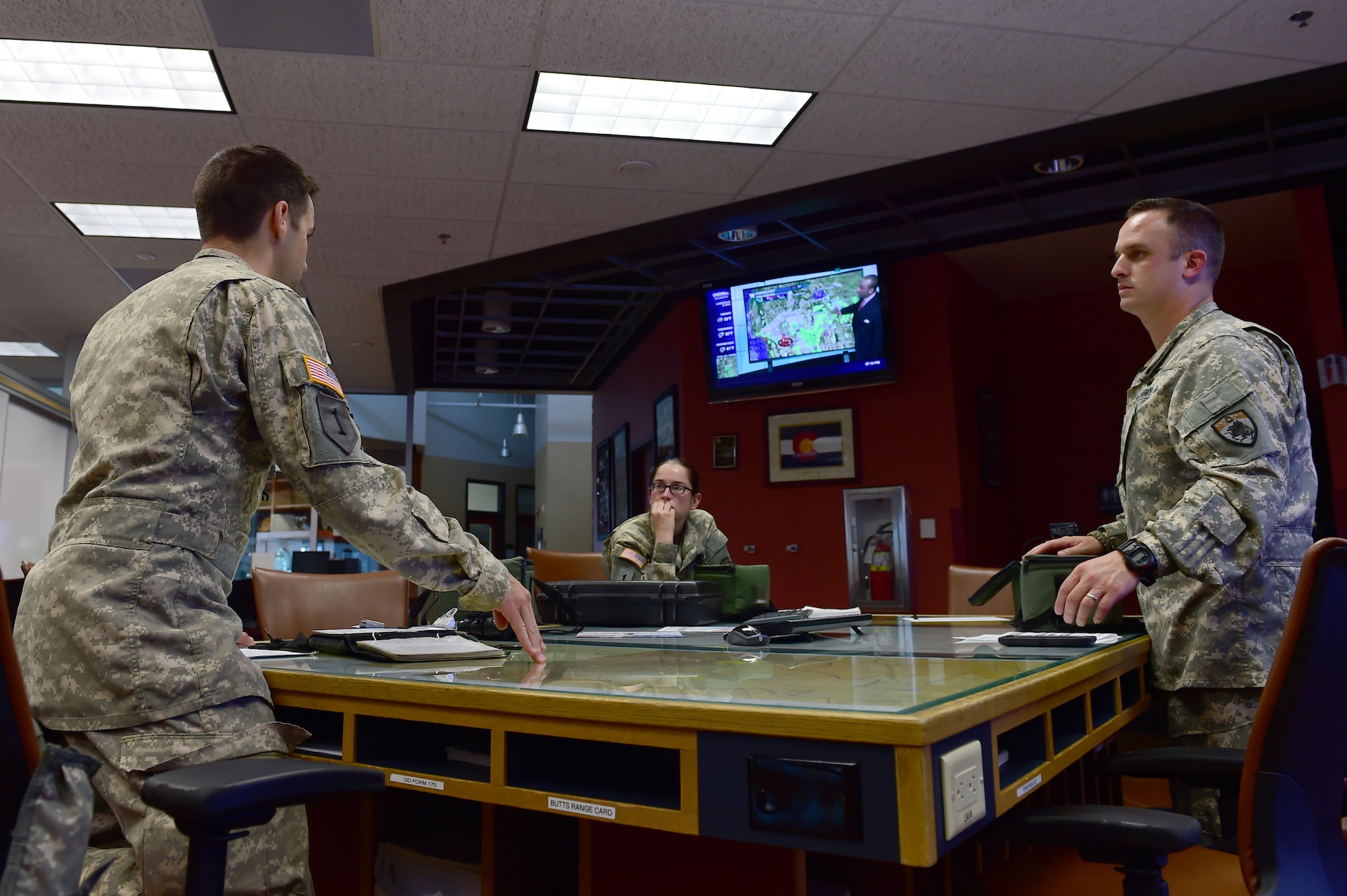 Chief Warrant Officer Craig Wenkheimer, 2-135th Aviation Battalion UH-60 Black Hawk pilot, gives a pre-flight briefing to 1st Lt. David Otero, 2-135th Aviation Battalion UH-60 Black Hawk pilot and Sgt. Barbara Shirley, 2-135th Aviation Battalion crew chief, July 29, 2015, on Buckley Air Force Base, Colo. The 2-135th Aviation Battalion is part of the Colorado Army National Guard and has a variety of capabilities that make it a valuable resource to both the state of Colorado and the U.S. Army. (U.S. Air Force photo by Airman 1st Class Luke W. Nowakowski/Released)
