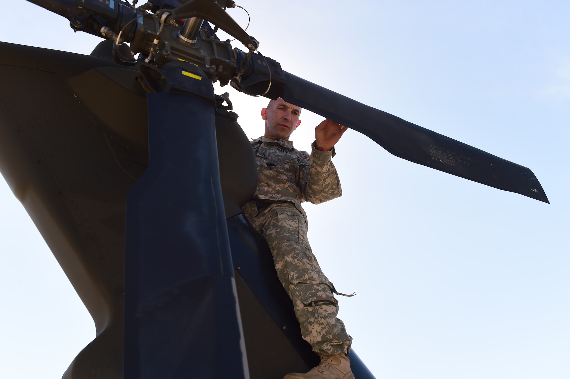 Staff Sgt. Steven Leflar, 2-135th Aviation Battalion crew chief, prepares a UH-60 Black Hawk before a flight July 29, 2015, on Buckley Air Force Base, Colo. The 2-135th Aviation Battalion is part of the Colorado Army National Guard and has a variety of capabilities that make it a valuable resource to both the state of Colorado and the U.S. Army. (U.S. Air Force photo by Airman 1st Class Luke W. Nowakowski/Released)