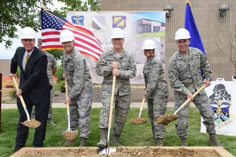 From left, Kevin Slattery, Doyon Government Group president, Col. Michael Kindt, 460th Medical Group commander, Col. Michael Cunningham, Air Force Dental Corps director, Lt. Col. Kelly Dorenkott, 460th Medical Operations Squadron commander and Col. John Wagner, 460th Space Wing commander, break ground on the new dental clinic Aug. 3, 2015, on Buckley Air Force Base, Colo. The expansion and reconfiguration of the 460th MDG and 140th MDG building is expected to be completed June 2016. (U.S. Air Force photo by Airman 1st Class Luke W. Nowakowski/Released)