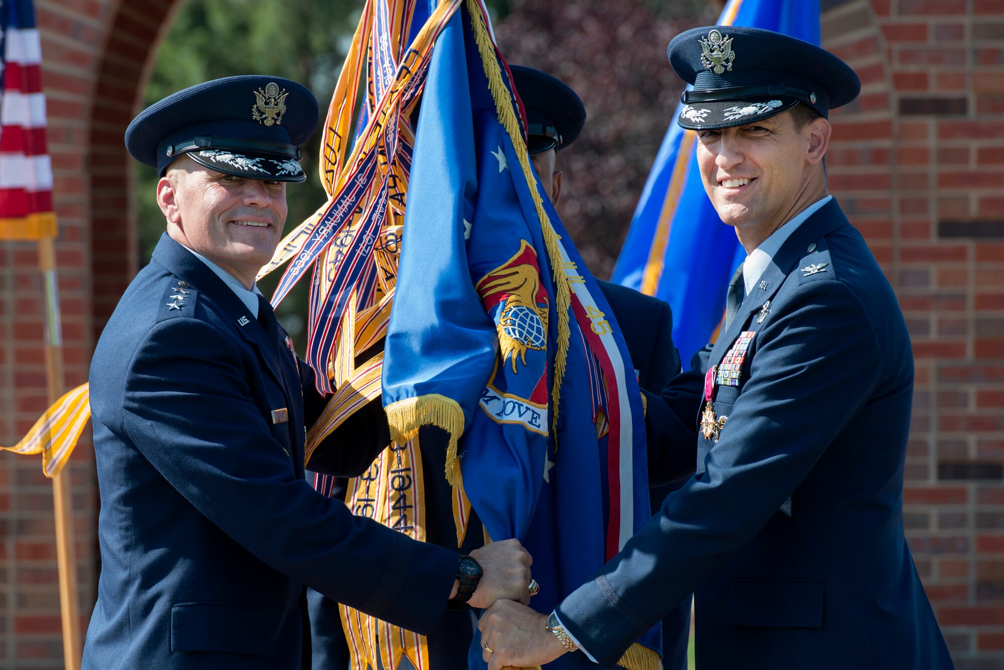 Col. Kyle Kremer, 375th Air Mobility Wing commander, relinquishes command of the 375th Air Mobility Wing during a change of command ceremony Aug. 3, 2015, at Scott Air Force Base, Ill. Col. Laura Lenderman, former Chief, Analysis Branch, Program and Budget Analysis Division, Joint Staff J-8 at Washington D.C. assumed command of the 375th AMW. (U.S. Air Force photo/ Airman 1st Class Kiana Brothers)