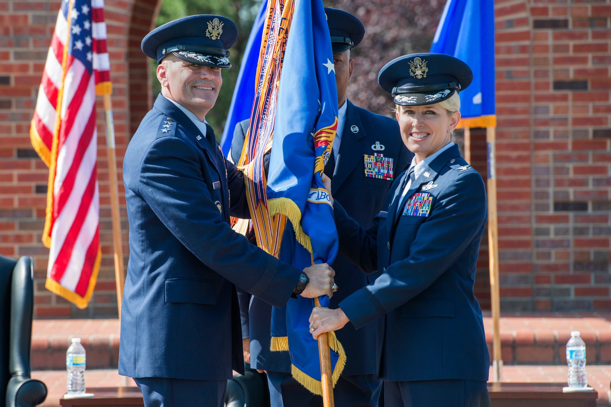 Col. Laura Lenderman, 375th Air Mobility Wing commander, receives the guidon from  Lt. Gen. Carlton Everhart, 18th Air Force Commander, during the 375th Air Mobility Wing's change of command ceremony Aug. 3, 2015, at Scott Air Force Base, Ill. Lenderman assumed command from Col. Kyle Kremer. (U.S. Air Force photo/ Airman 1st Class Kiana Brothers)