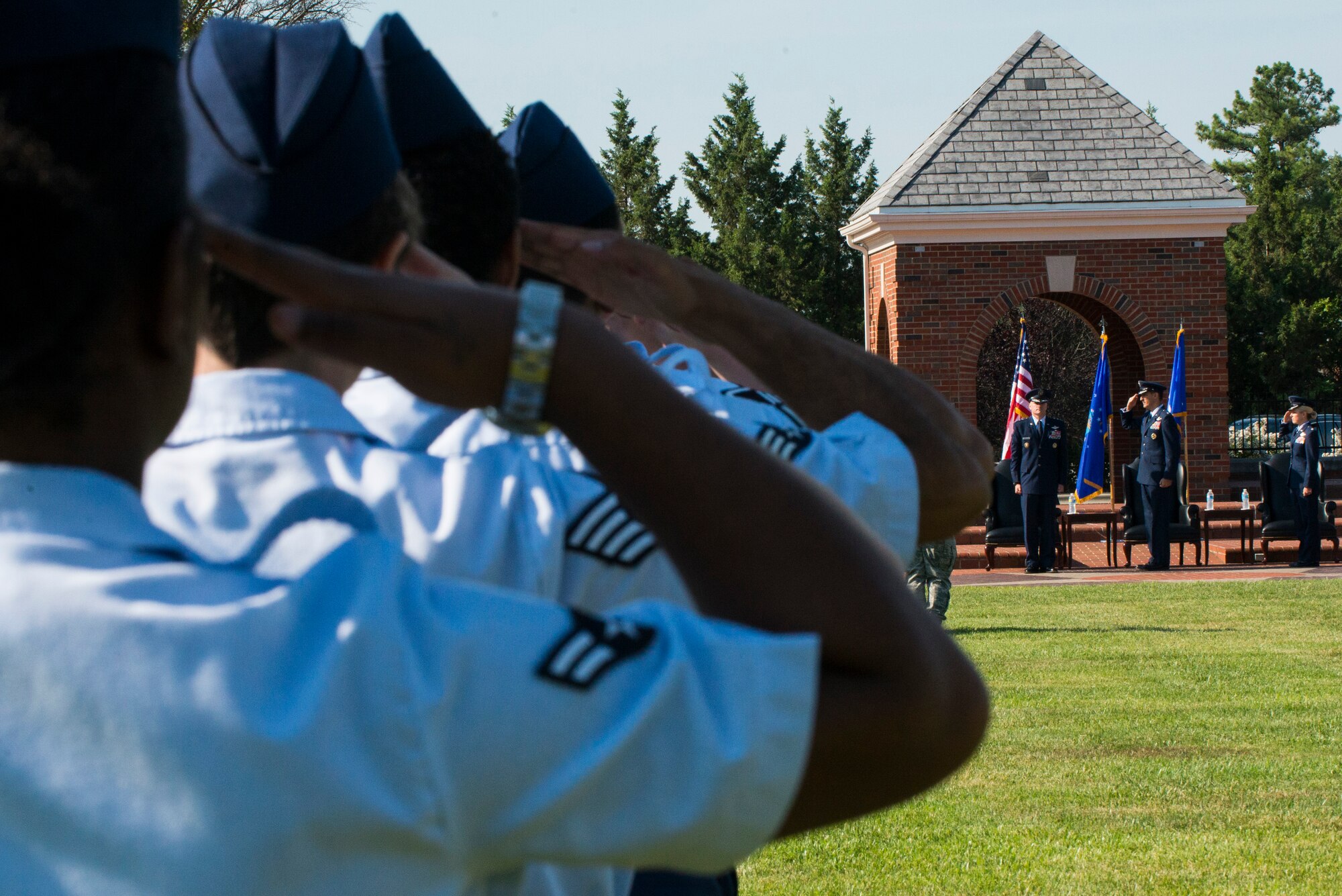 Military members render a salute to Lieutenant General Carlton Everhart, Commander 18th Air Force, during the playing of ruffles and flourishes at the 375th Air Mobility Wing Change of Command, August 3, 2015 on Scott Air Force Base, Ill. Ruffles and flourishes are musicals embellishments that are played before the entry of high-ranking officials as a sign of respect. (U.S. Air Force photo/ Senior Airman Tristin English)