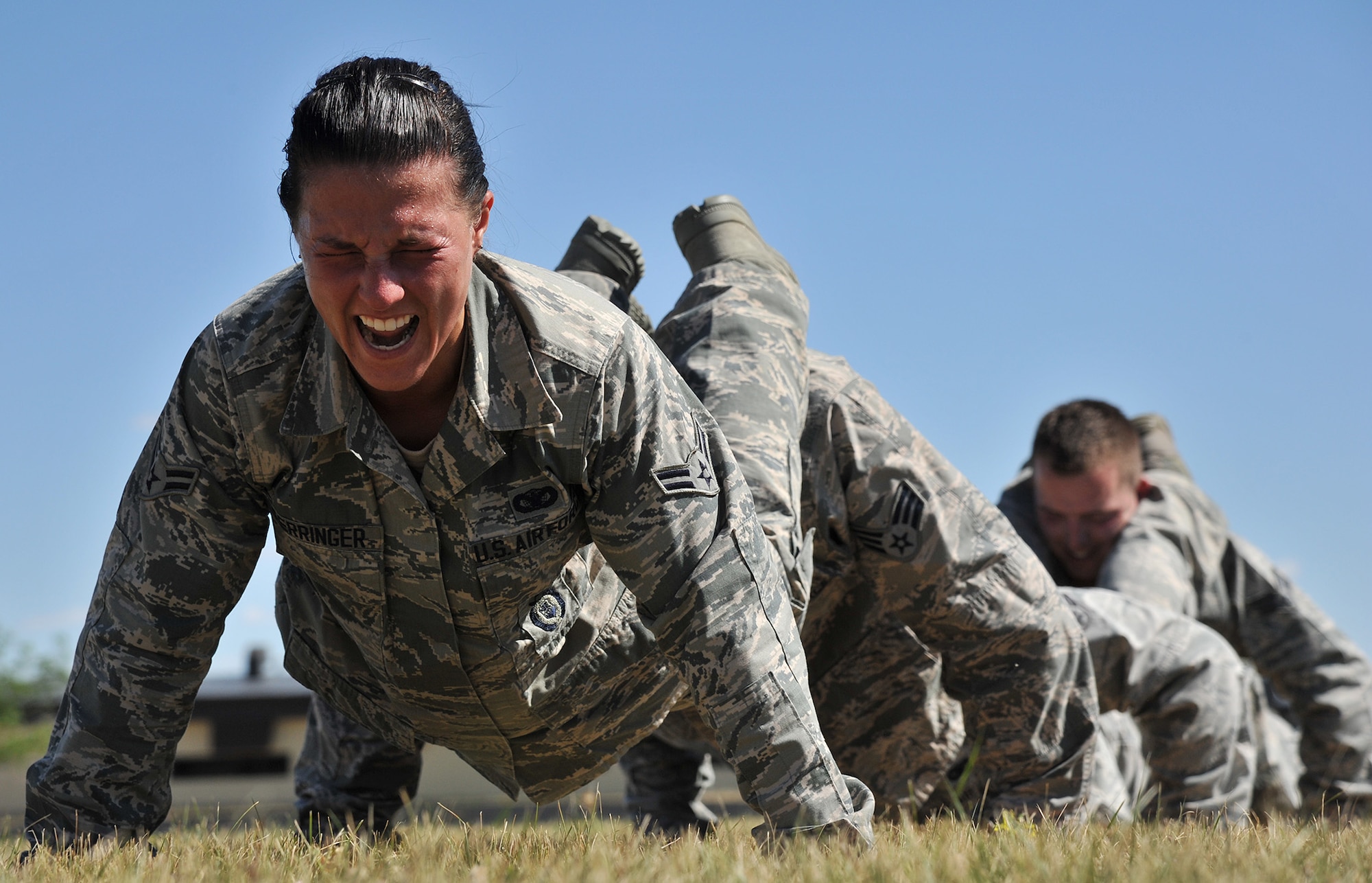 Airman 1st Class Amy Ferringer, 341st Missile Security Forces Squadron, counts a repetition of a synchronized group push-up July 29 during tryouts for Malmstrom’s Global Strike Challenge 2015 security forces team. The tryouts were July 27-30 at the fitness center’s track and field and were open to all members of the 341st Security Forces Group. (U.S. Air Force photo/John Turner)