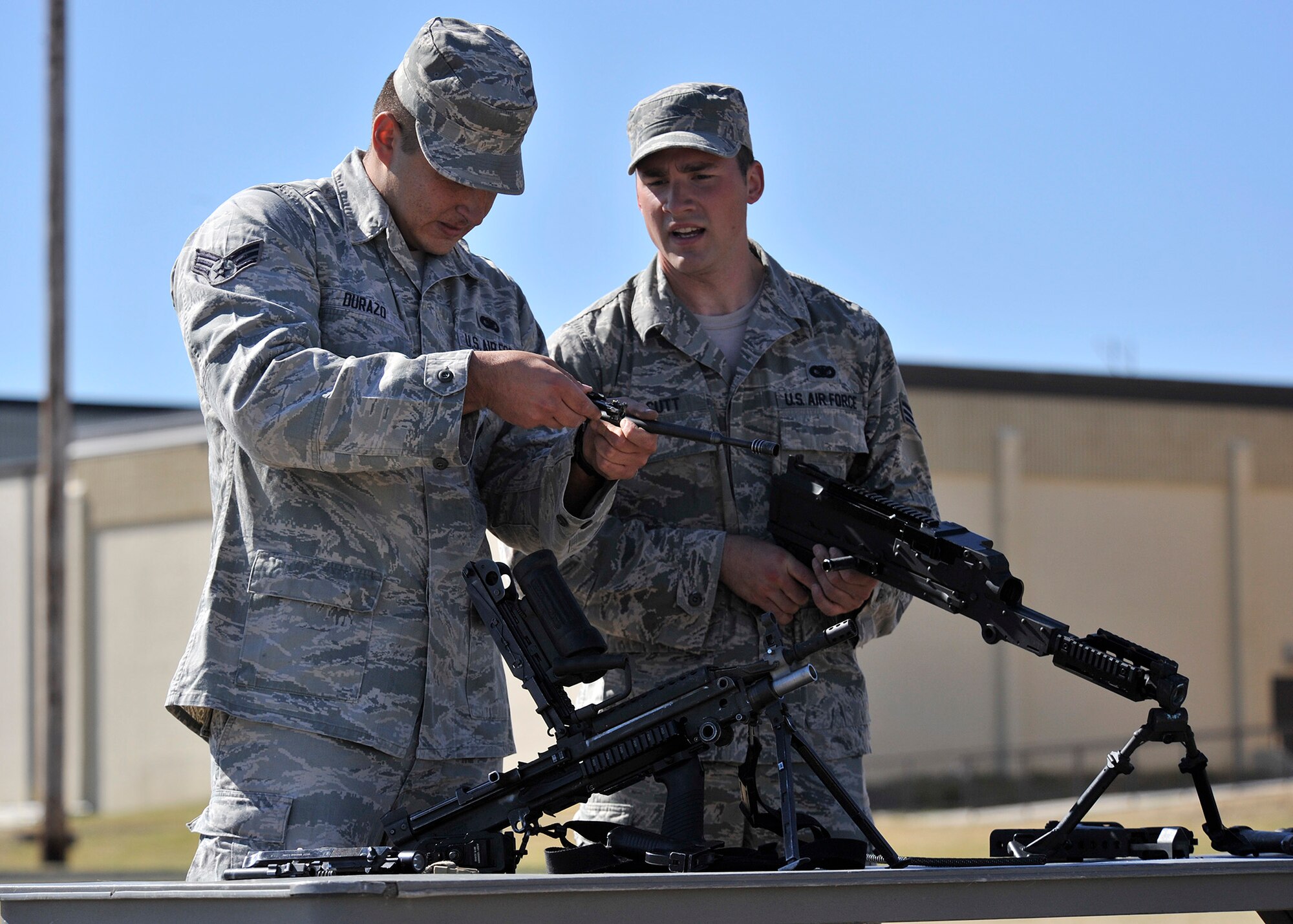Senior Airmen Robert Durazo, left, and Daniel Orcutt, both 741st Missile Security Forces Squadron tactical response force members, work together to quickly assemble five weapons July 29 during tryouts for Malmstrom’s Global Strike Challenge 2015 security forces team. The tryouts were July 27-30 at the fitness center’s track and field and were open to all members of the 341st Security Forces Group.  (U.S. Air Force photo/John Turner)
