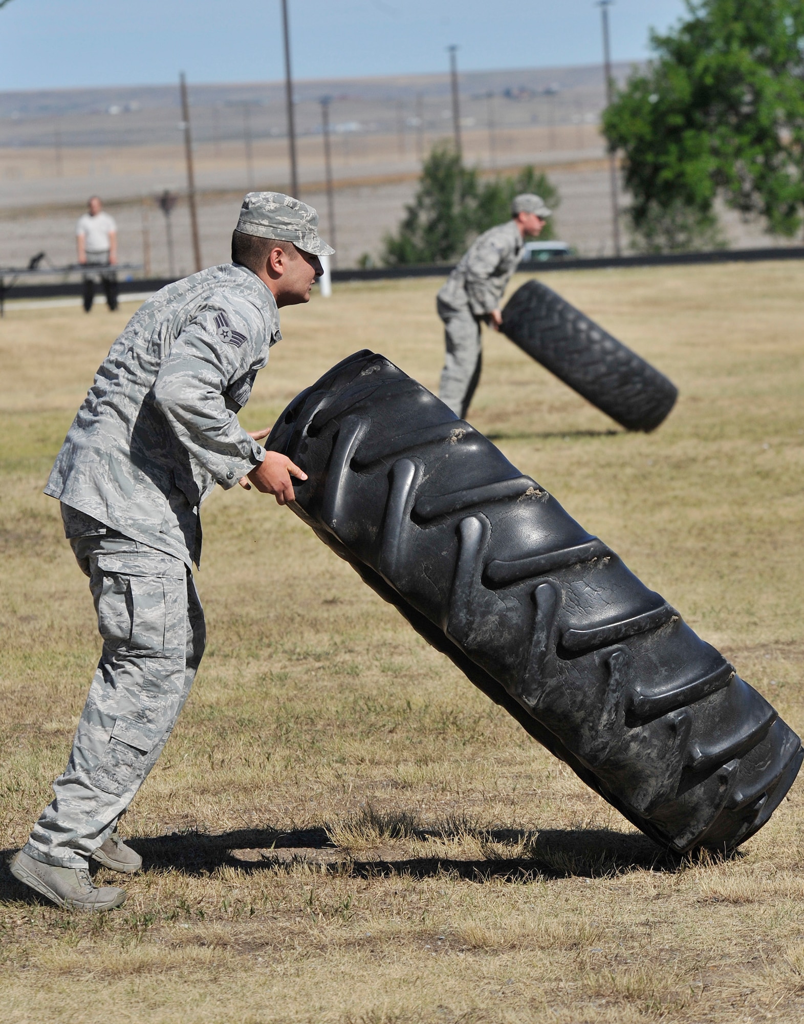 Senior Airmen Robert Durazo, left, and Daniel Orcutt, both 741st Missile Security Forces Squadron tactical response force members, flip tractor tires July 29 during tryouts for Malmstrom’s Global Strike Challenge 2015 security forces team. The tryouts were July 27-30 at the fitness center’s track and field and were open to all members of the 341st Security Forces Group.  (U.S. Air Force photo/John Turner)