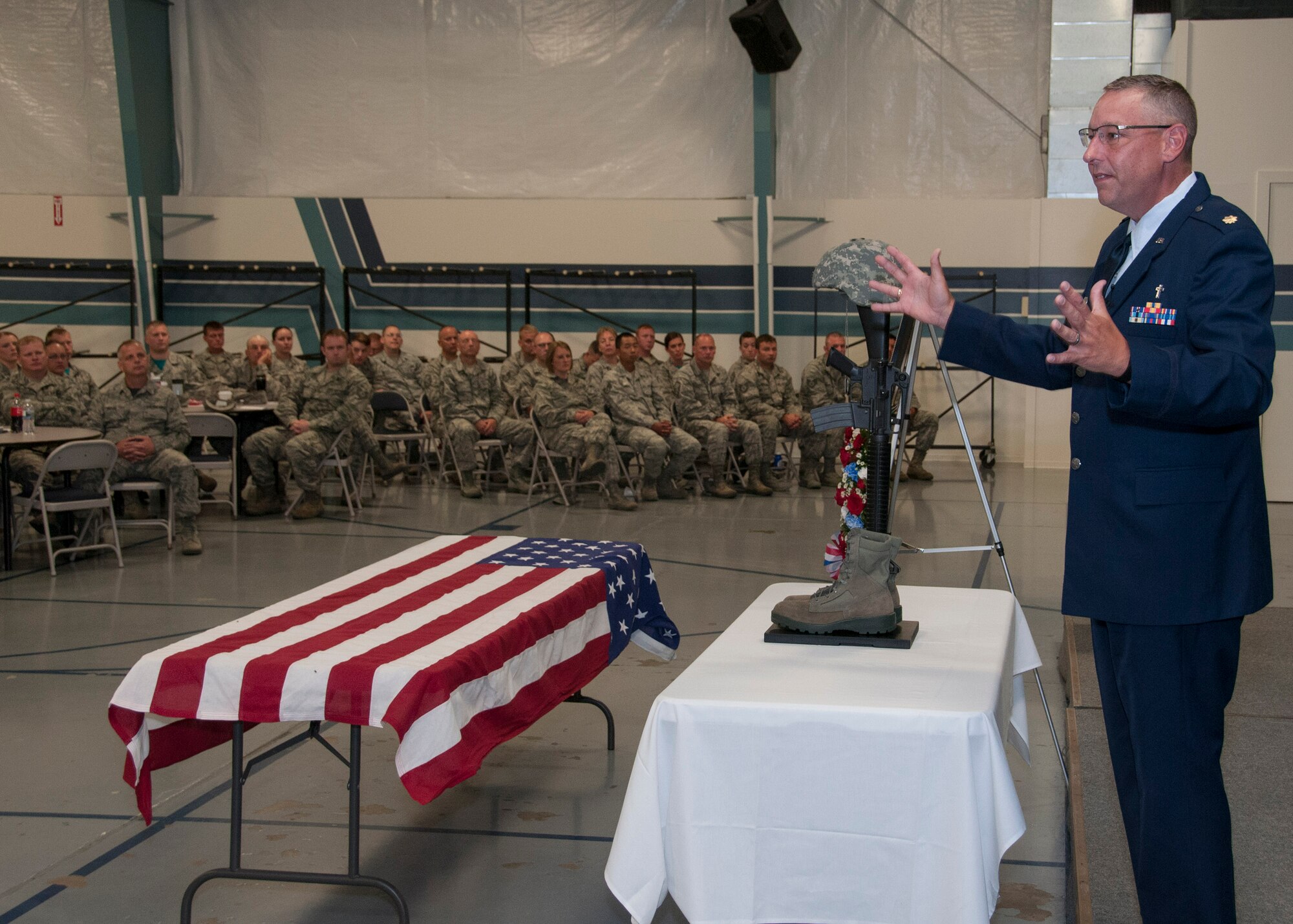 Maj. Steve Peters, a chaplain with the 185th Air Refueling Wing, preaches to members of the 185th ARW during a memorial service for Senior Airman Drew Bellairs in Sgt. Bluff, Iowa on August 1, 2015. The memorial service honored Bellairs who passed away on July 25, 2015. (U.S. Air National Guard Photo by: Tech Sgt. Oscar Sanchez/185th ARW Wing Public Affairs Released)