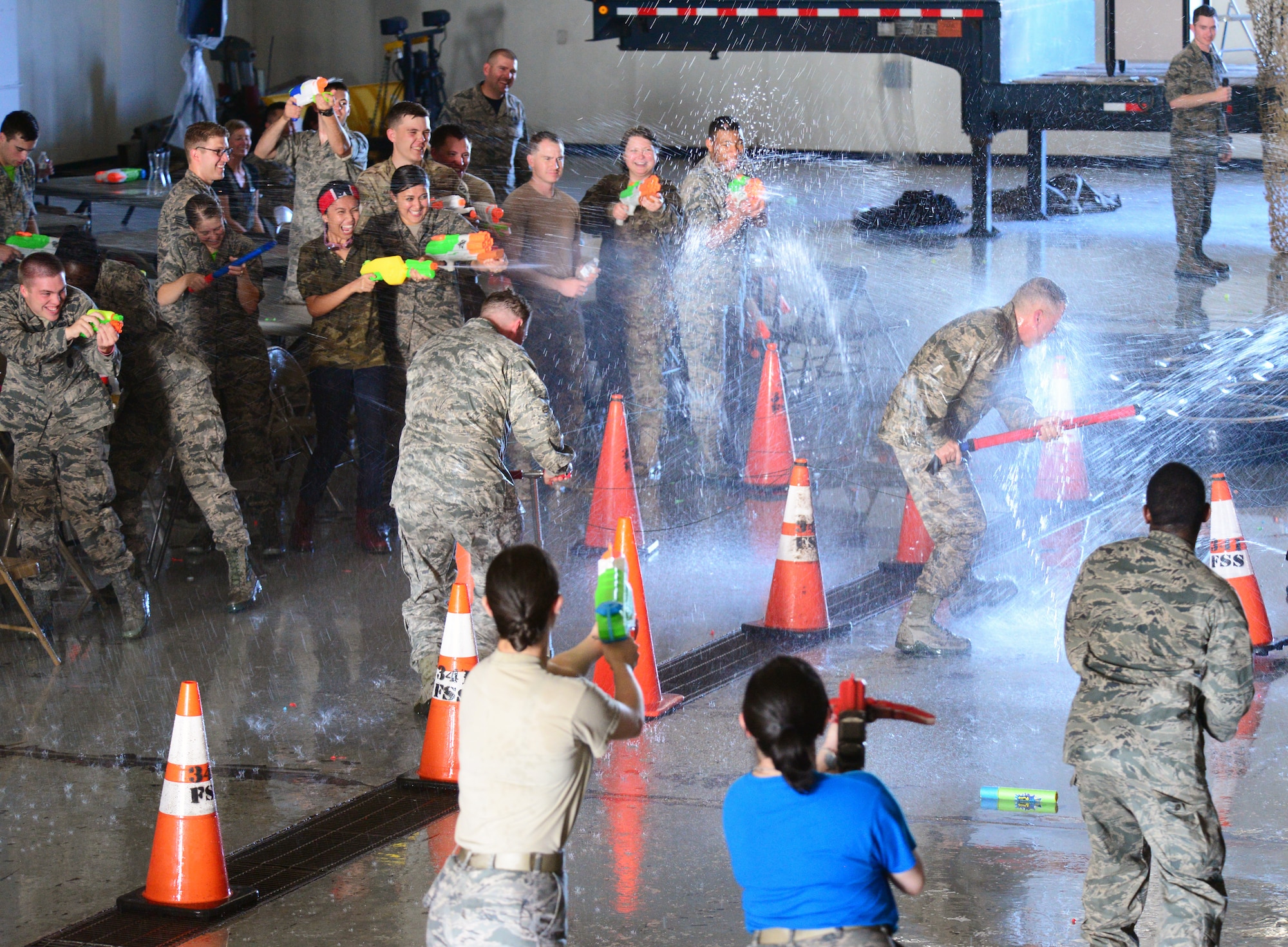 Airmen from the 341st Missile Wing soak the 341st Security Forces Group Commander, Col. Kenneth O'Neil, and the 341st MW Commander, Col. Tom Wilcox, at a combat dining out July 31, 2015, at Malmstrom Air Force Base, Mont. Airmen were encouraged to bring water-weapons to do battle at the mess with their fellow Airmen and the base leadership. (U.S. Air Force photo/Airman 1st Class Magen M. Reeves)