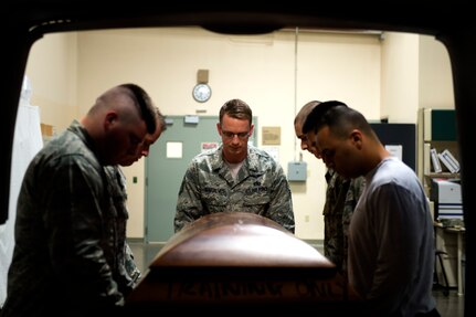 Master Sgt. Marc Gonsalves, 9th Airlift Squadron, prepares to conduct a reverse dignified transfer during a training session at the Charles C. Carson Center for Mortuary Affairs, Dover Air Force Base, Del., July 24, 2015. Airmen assigned to Dover AFB support the Air Force Mortuary Affairs Operations’ mission by performing the reverse dignified transfer for the fallen travelling by contract air. (U.S. Air Force photo/Senior Airman Robert Gunn)