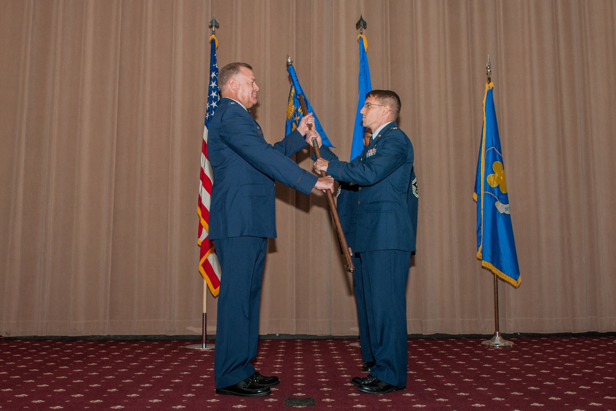 U.S. Air Force Lt. Col. Leo Kamphaus, commander of the 307th Maintenance Group, passes command of the 307th Maintenance Squadron to Maj. George Cole III on Aug. 1, 2015 at Barksdale Air Force Base, La. Cole is the former individual mobilization augmentee to the 18th Air Force Director of Logistics, Scott AFB, Ill . (U.S. Air Force photo by Master Sgt. Dachelle Melville/Released)