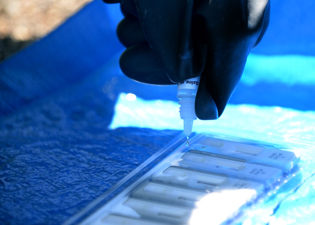 Airmen of the 28th Medical Operation Squadron bioenvironmental engineering flight use a hand-held assay during an integrated base emergency response capabilities training exercise at Camp Lancer at Ellsworth Air Force Base, S.D., July 16, 2015. Airmen used the HHA to identify possible biological agents in unknown chemicals found during the exercise. (U.S. Air Force photo by Senior Airman Rebecca Imwalle/Released)