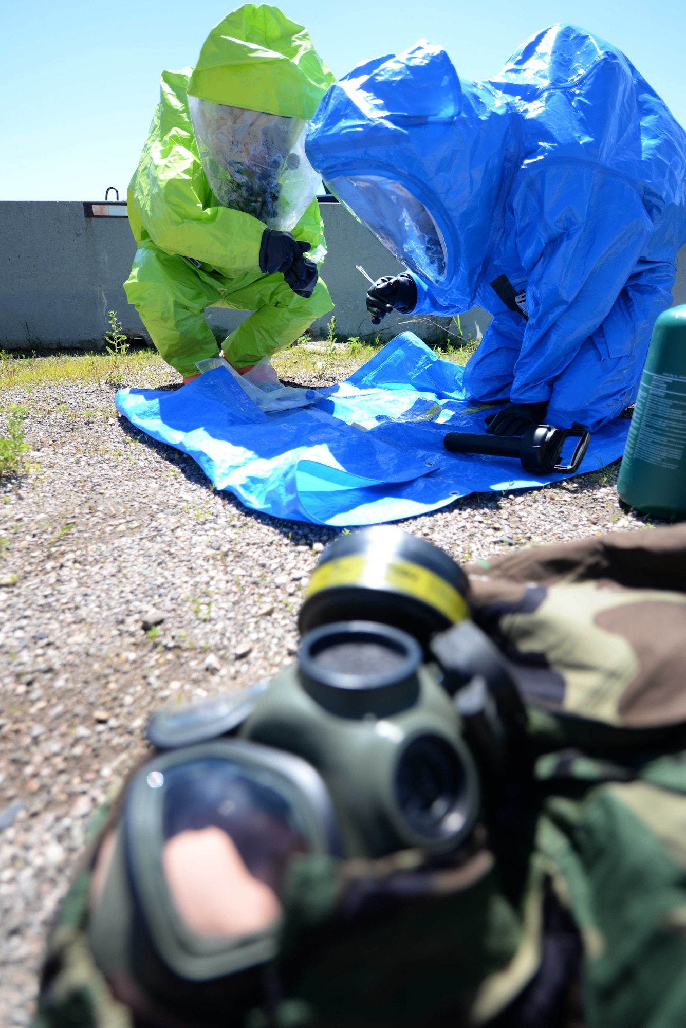 Airmen of the 28th Medical Operation Squadron bioenvironmental engineering flight test unknown chemicals during an integrated base emergency response capabilities training exercise at Camp Lancer at Ellsworth Air Force Base, S.D., July 16, 2015. The goal of this training was to safely evaluate the situation and test chemicals to determine if biological agents were present while building cohesiveness between participating units. (U.S. Air Force photo by Senior Airman Rebecca Imwalle/Released) 