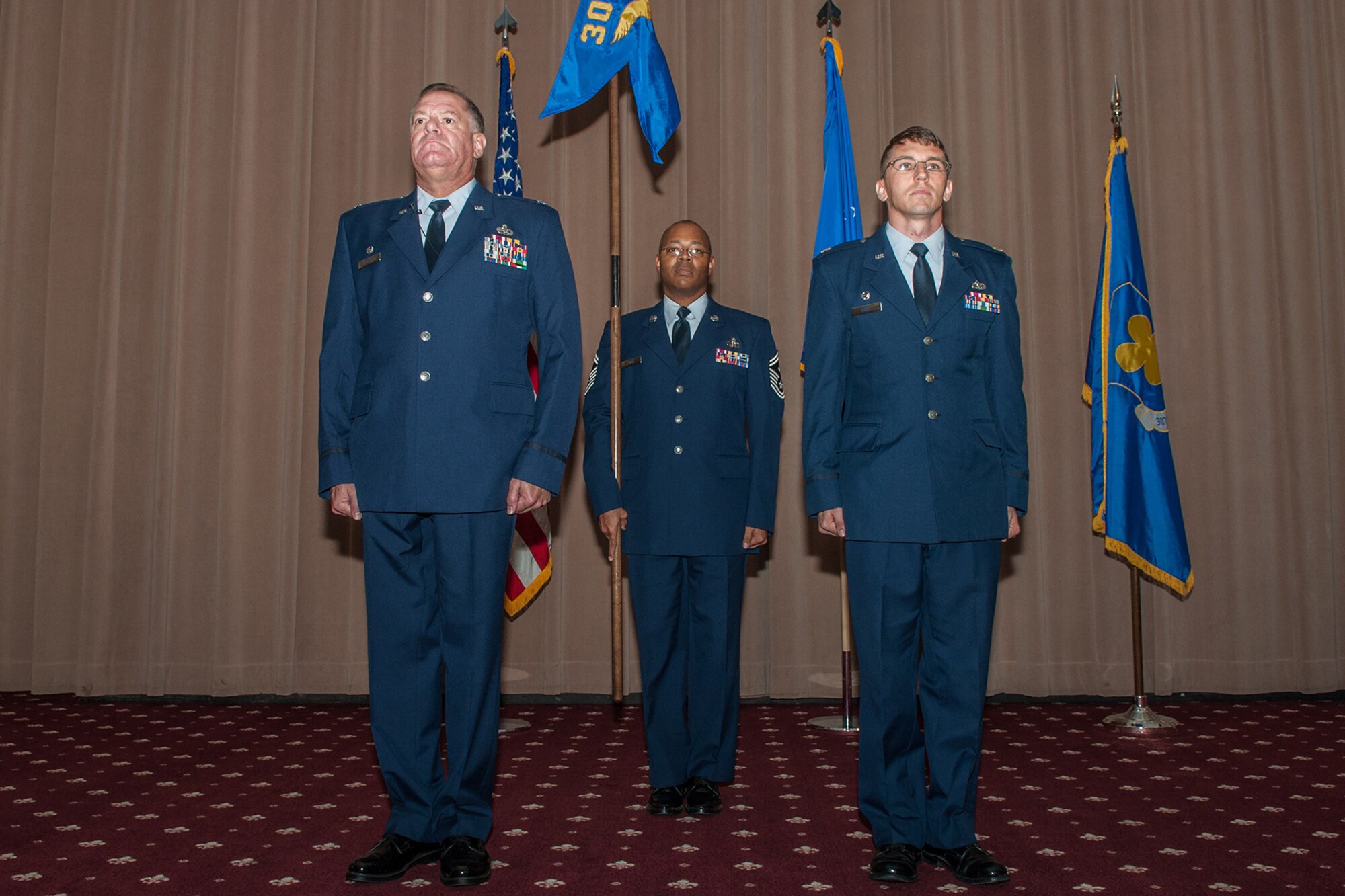 U.S. Air Force Lt. Col. Leo Kamphaus, commander of the 307th Maintenance Group, prepares to hand the reign of command for the 307th Maintenance Squadron to Maj. George Cole III in an assumption of command ceremony on August 1, 2015 at Barksdale Air Force Base, La. Senior Master Sgt. Norman Ford, the First Sergeant of the 307th Maintenance Squadron, also acted as guidon bearer for the ceremony. Cole is the former individual mobilization augmentee to the 18th Air Force Director of Logistics, Scott AFB, Ill. (U.S. Air Force photo by Master Sgt. Dachelle Melville/Released)